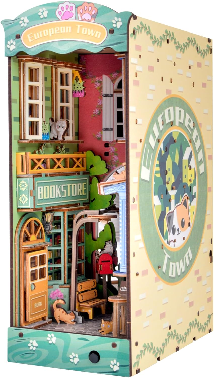 Close-up of Cat Street Gallery book nook insert featuring a ginger cat, European town architecture, and bookstore sign.-uFunSpace