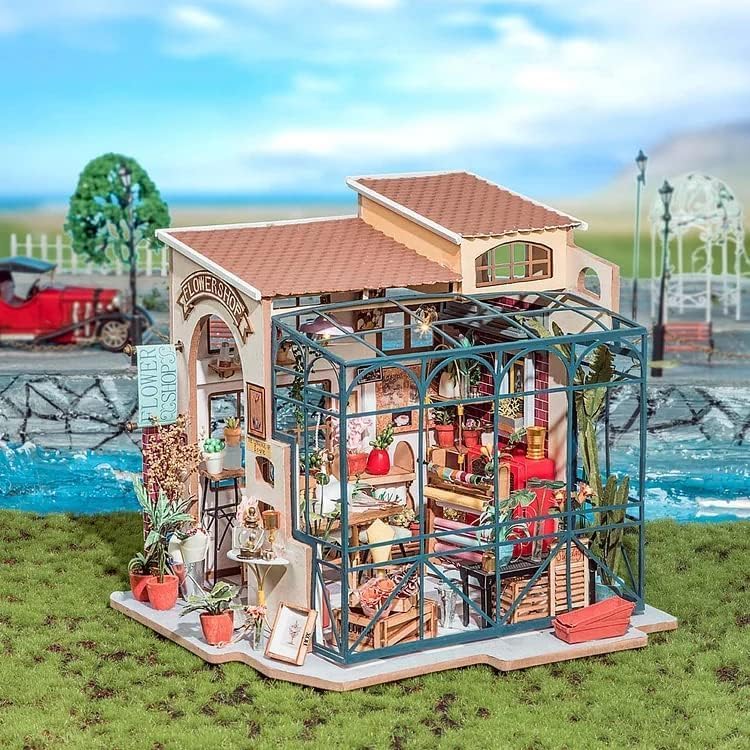 Completed Emily's Flower Shop model displayed in an outdoor garden setting for home decor inspiration.
