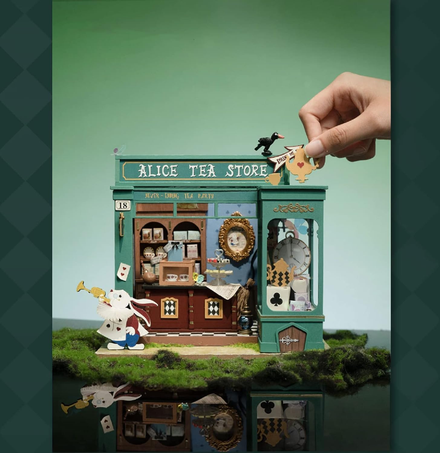 Hand assembling the final teapot roof sign on the Rolife Alice's Tea Store DIY miniature house kit, showing scale and ease of build.-uFunSpace