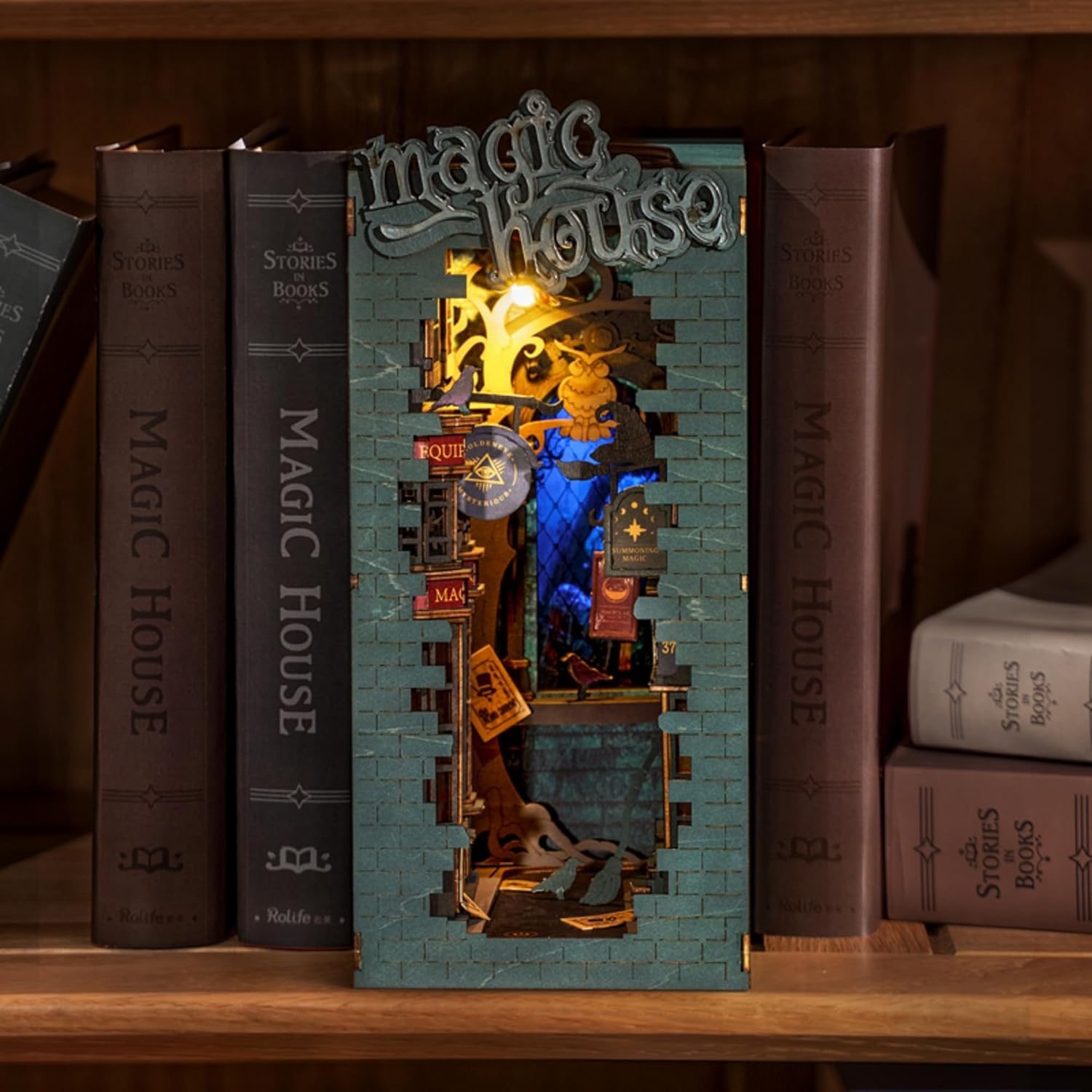Magic House DIY bookend inserted between books, featuring blue background lights and wizard decor.-uFunSpace