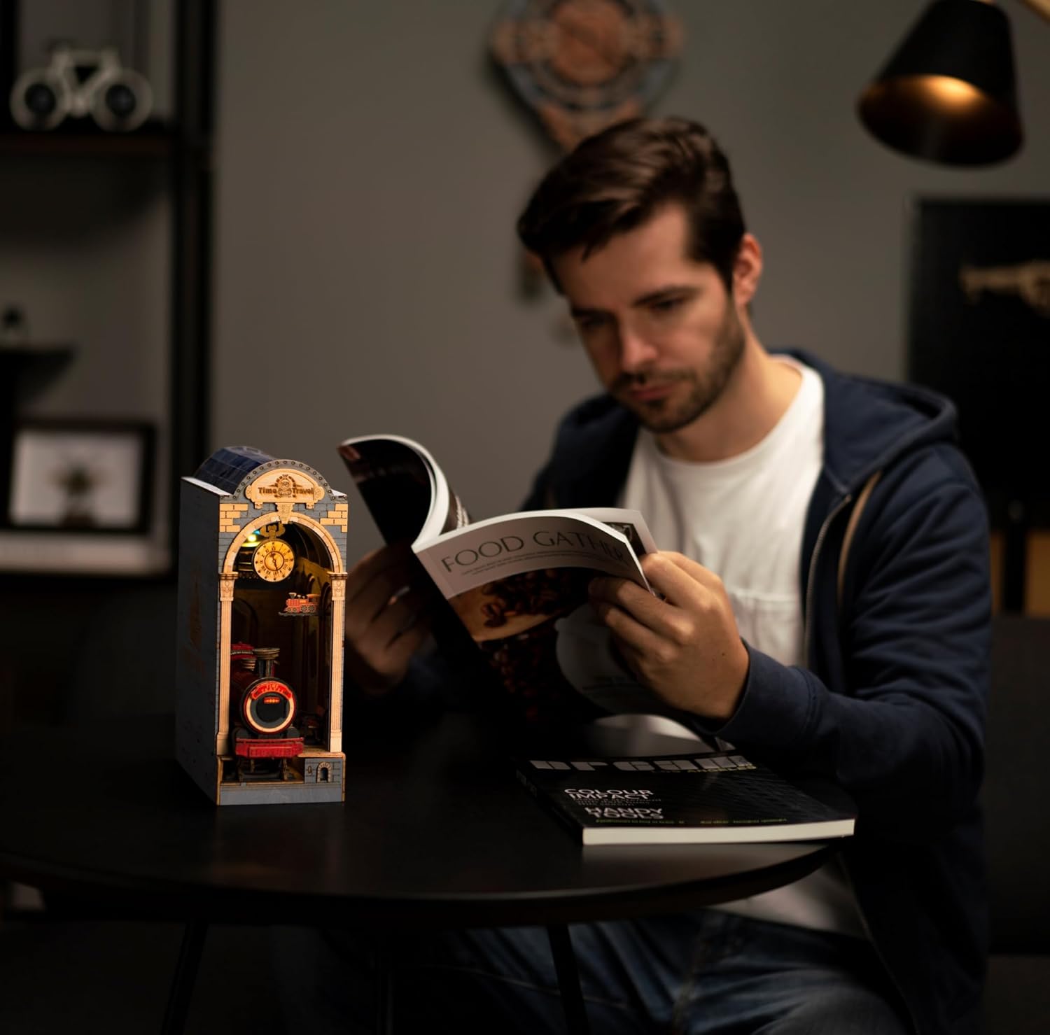 Man reading a book next to the finished Time Travel Book Nook, illustrating it as a perfect home decor gift for men and adults.-uFunSpace