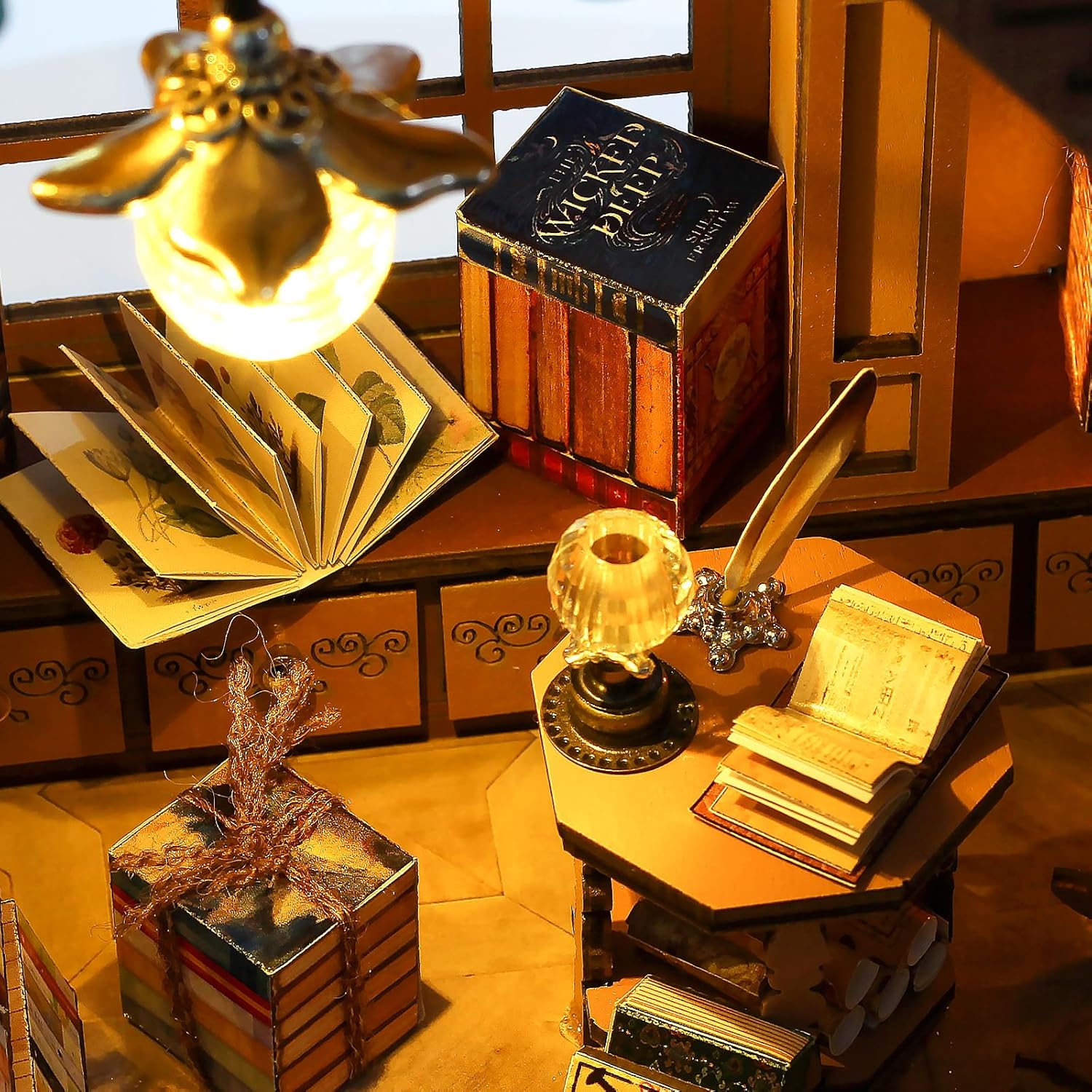 Macro shot of miniature desk accessories: a quill pen, open spell book, glowing crystal lamp, and 'The Wicked Deep' magic book.-uFunSpace