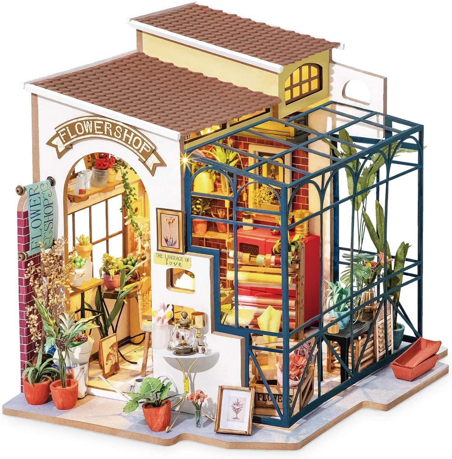 Side view of the miniature greenhouse kit showing the glass roof structure and flower display racks.
