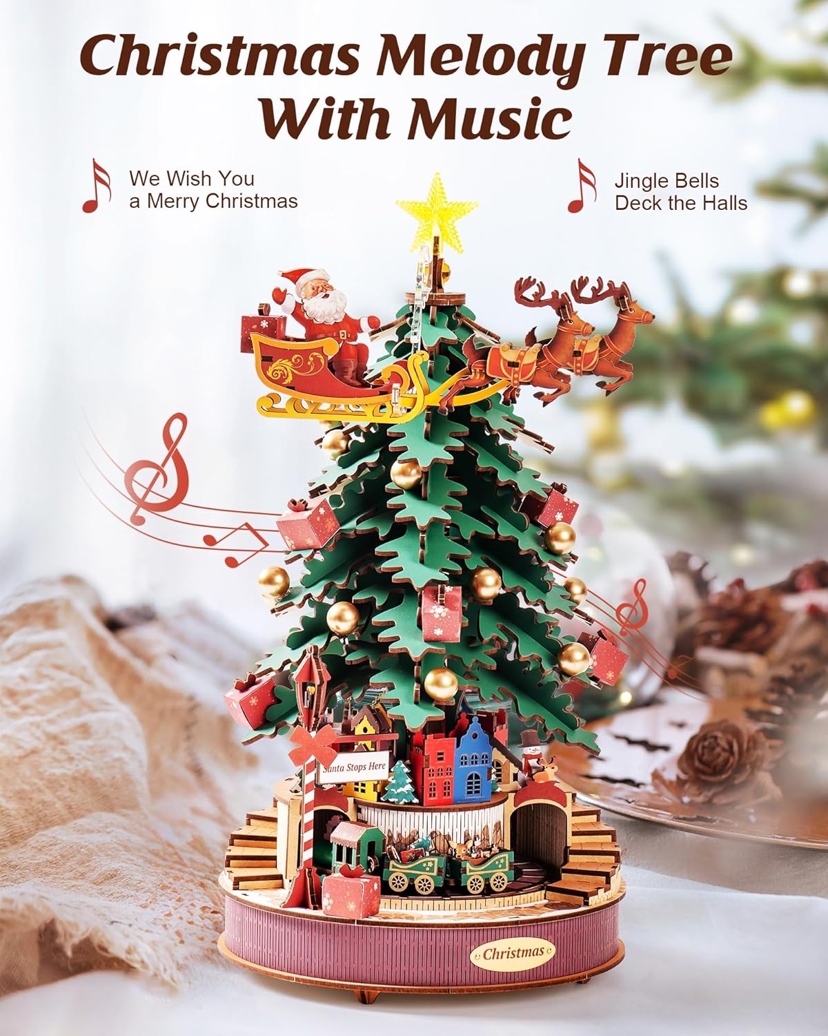 Christmas Melody Tree music box fully assembled on a table, displaying a festive holiday atmosphere with "Merry Christmas" text-uFunSpace