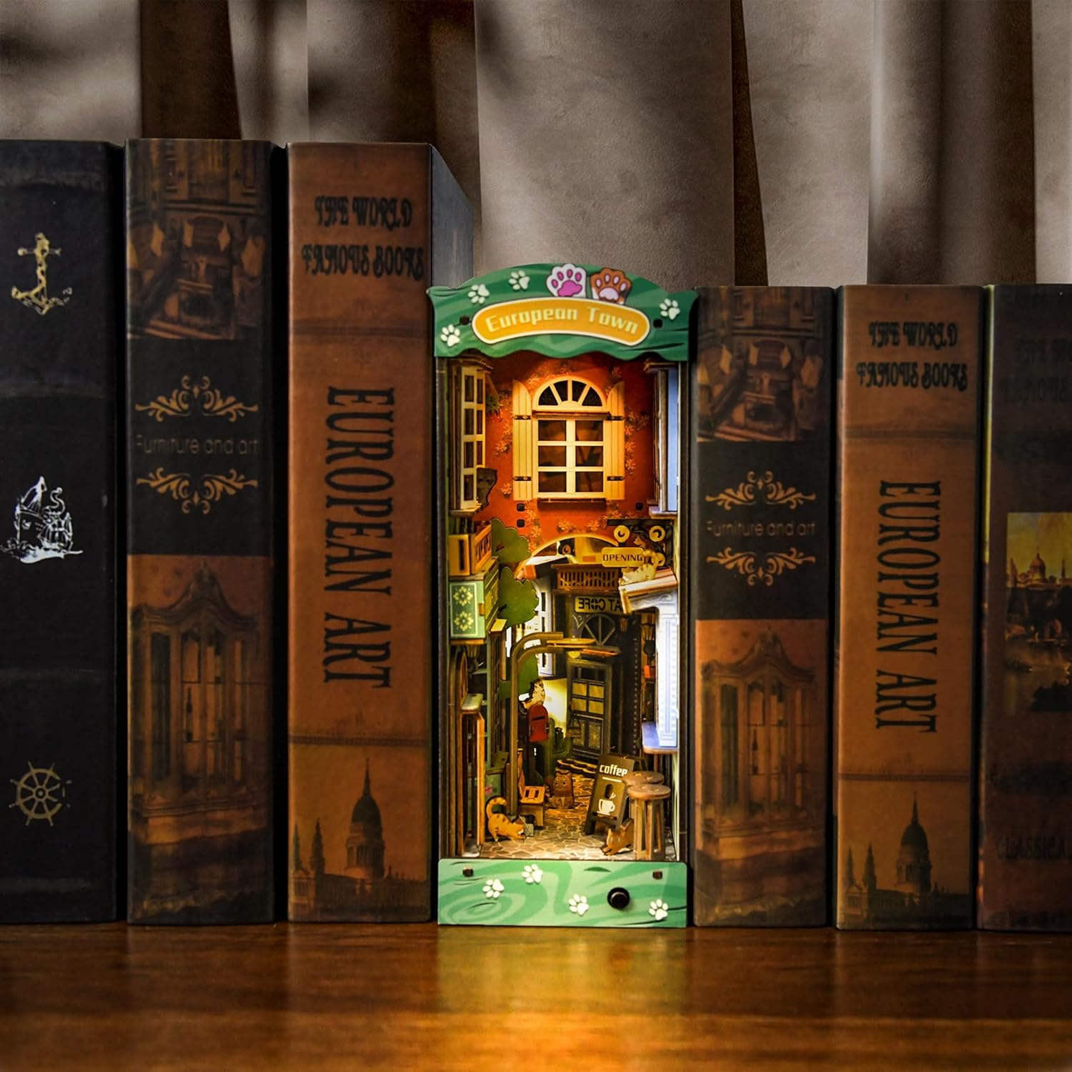 Illuminated Cat Street Gallery bookend with warm LED lights, showing a cozy European alleyway scene between books.-uFunSpace