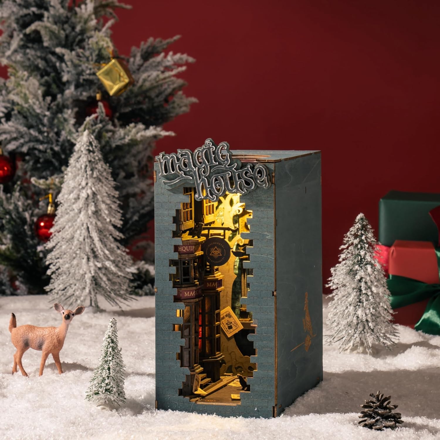 Magic House Book Nook displayed as a Christmas decoration with snow, pine trees, and warm lighting.-uFunSpace