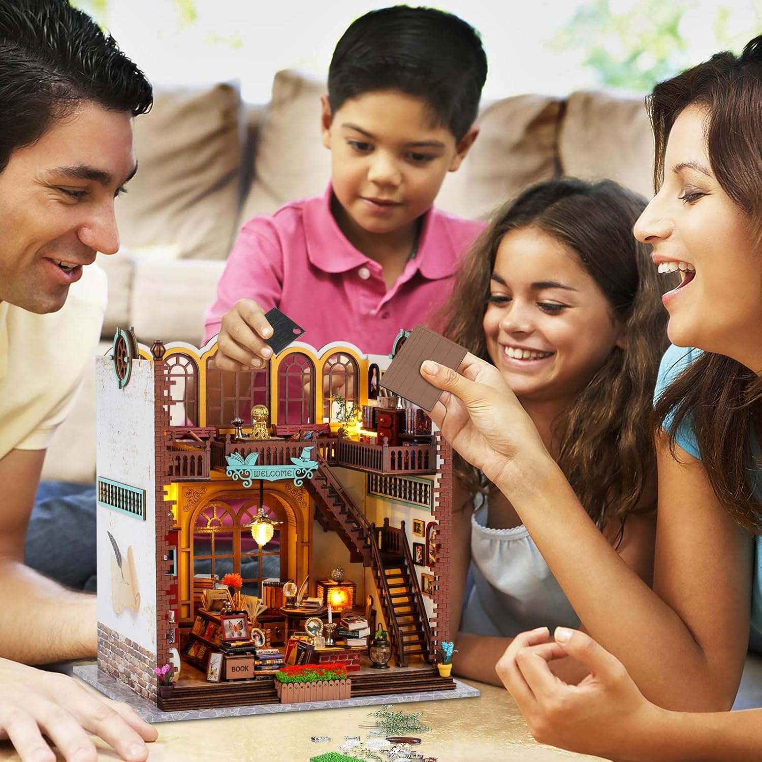 Happy family of four enjoying building the Magic Book Store 3D wooden puzzle together on the floor, suitable for adults and kids.-uFunSpace
