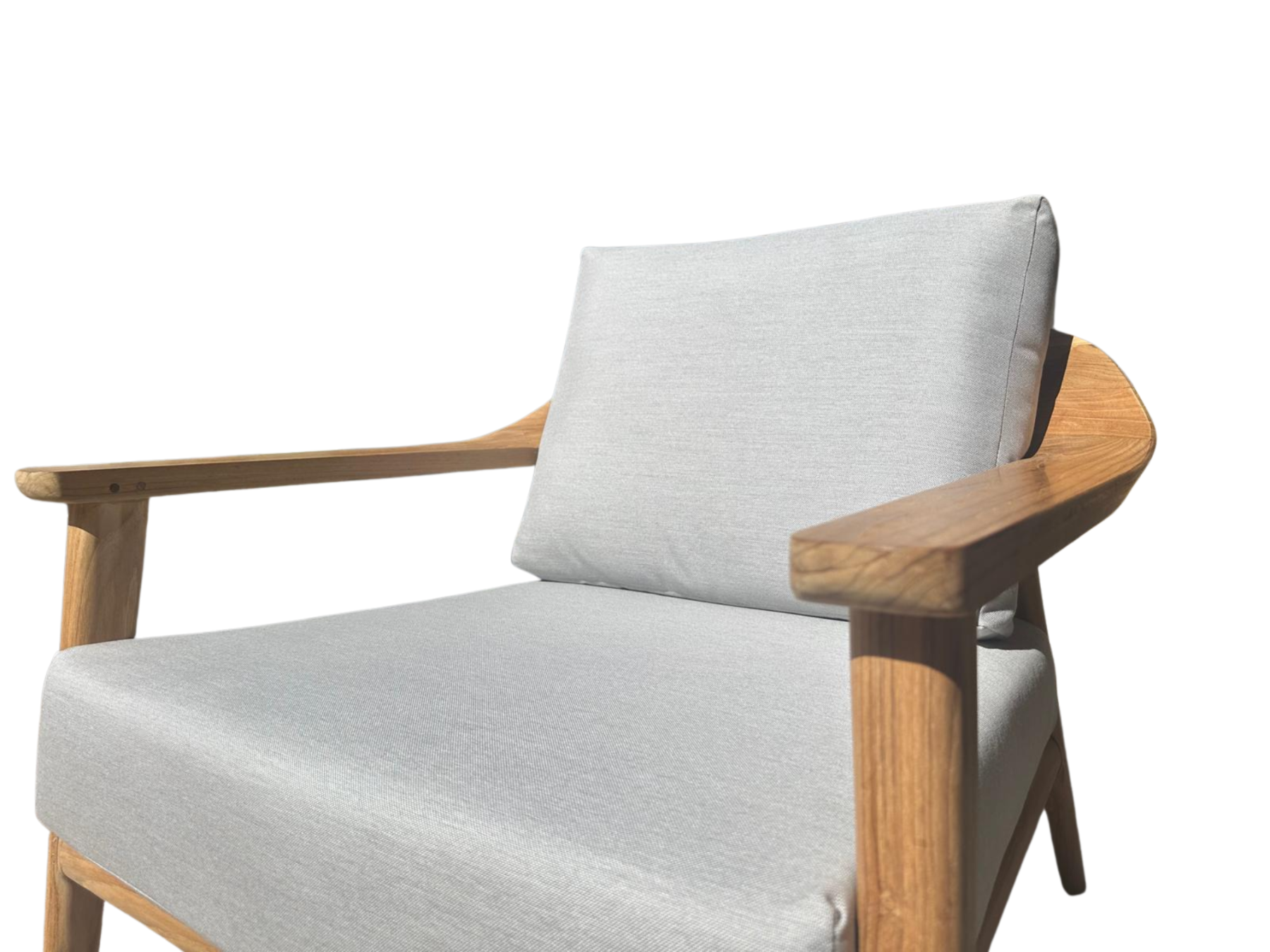 Front angled view of the Veluta Curve FSC® certified solid teak outdoor armchair with light grey seat and back cushions