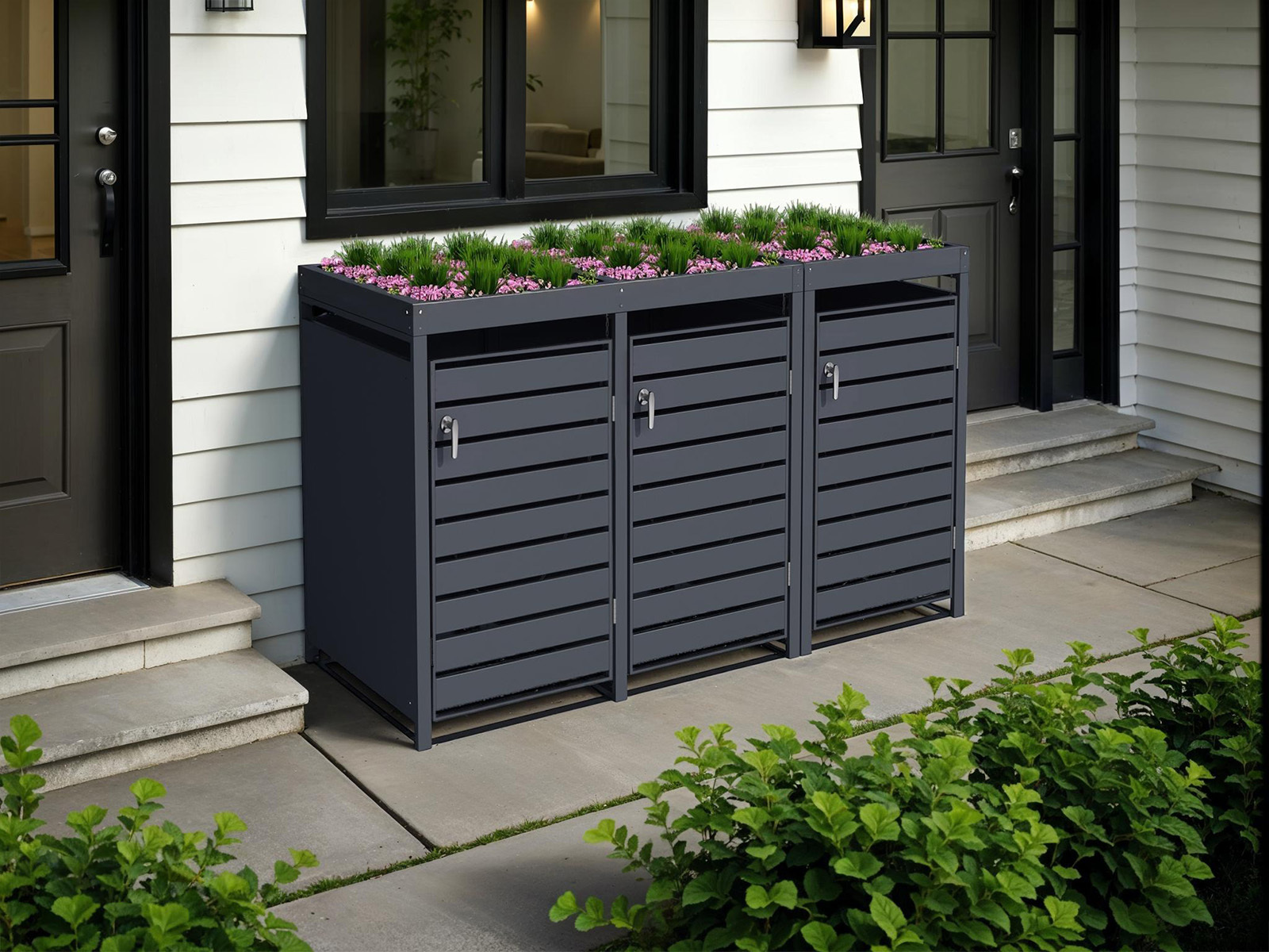 Triple anthracite bin store with integrated planter filled with flowers outside modern home