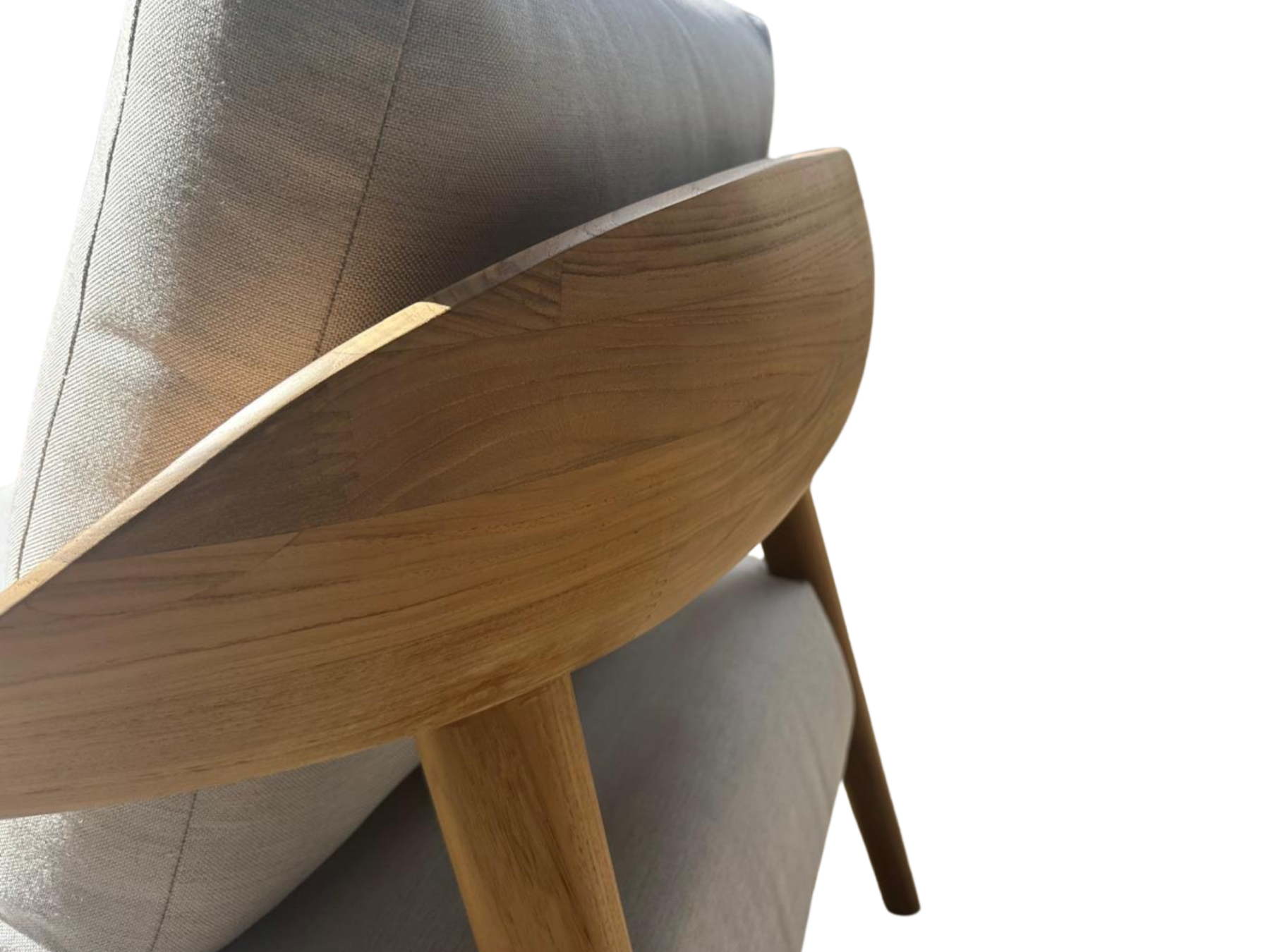 Close-up of the Veluta Curve FSC® certified solid teak outdoor armchair showcasing the sculpted curved backrest and premium craftsmanship
