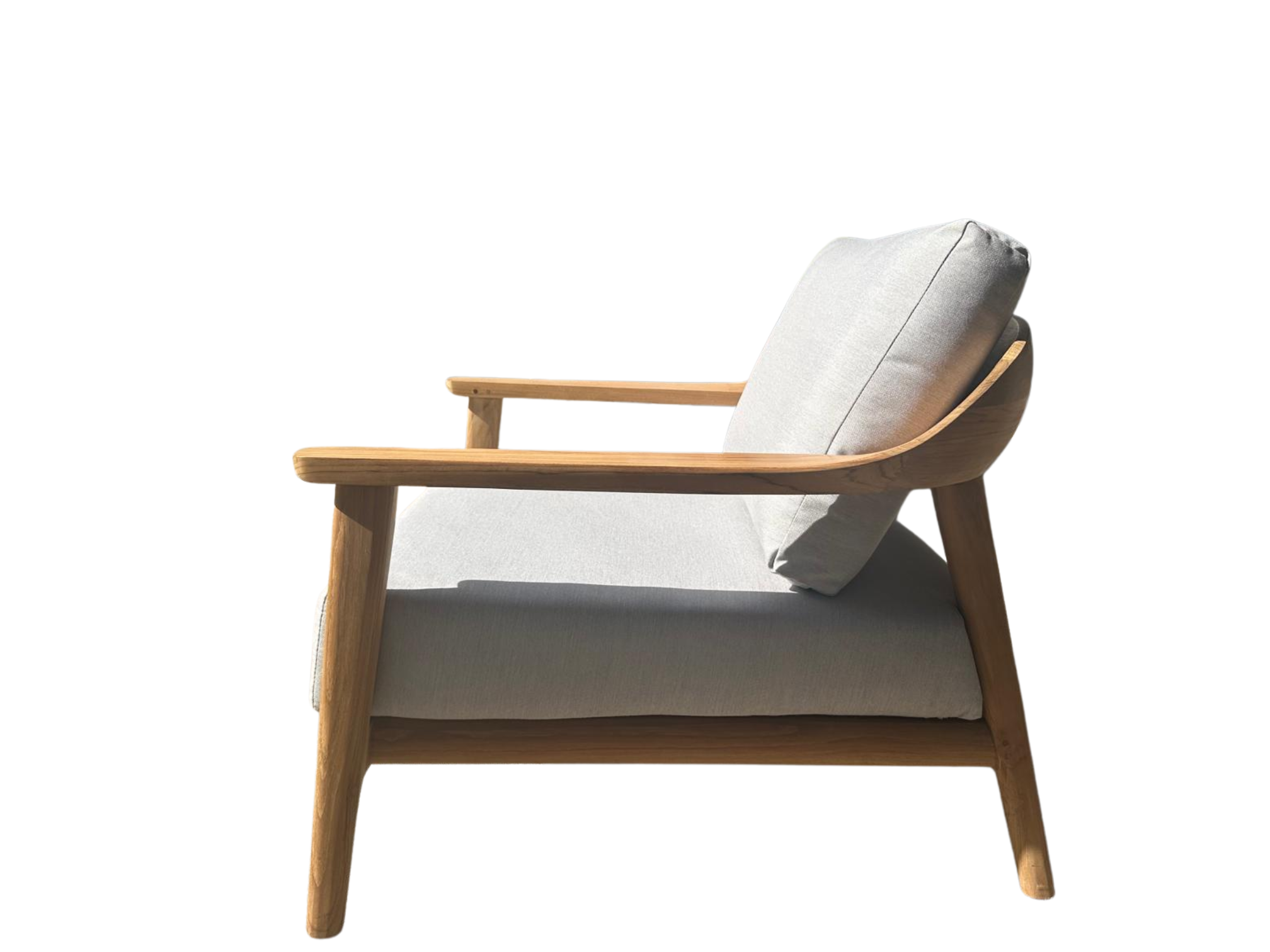 Side view of the Veluta Curve FSC® certified teak garden armchair with deep cushions and ergonomic curved armrests