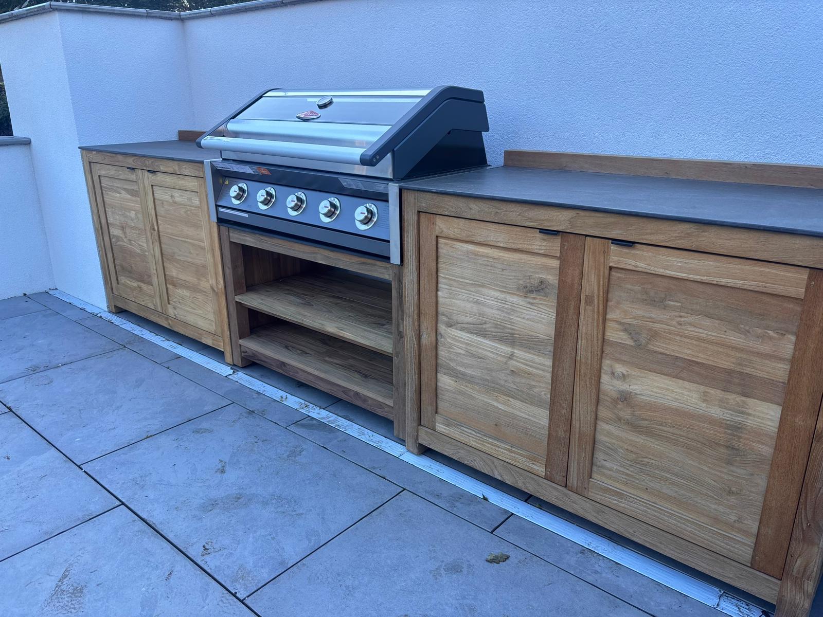 Close-up of Bari outdoor kitchen BBQ grill station with teak cabinets