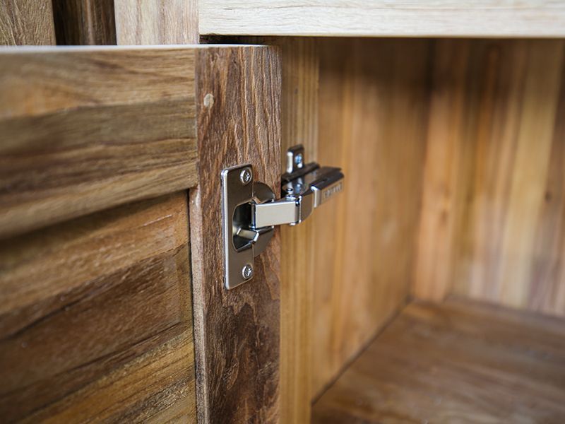 Close-up of soft-close hinge inside Bari teak outdoor kitchen double door cabinet