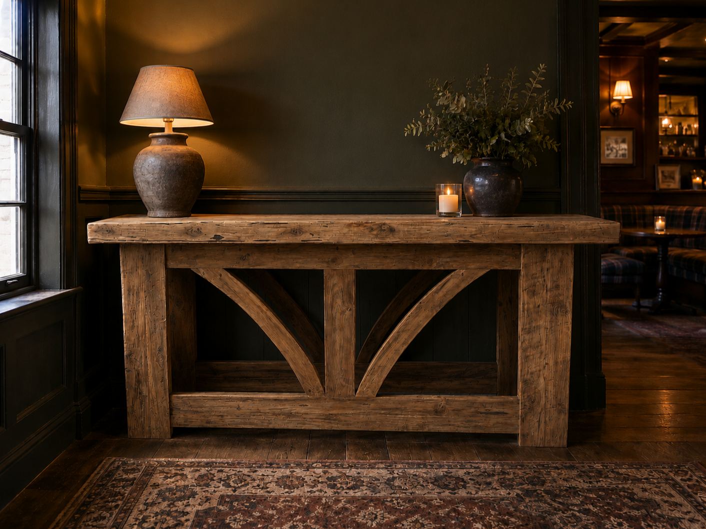 Kendal 2m teak console table styled against a dark panelled wall in a traditional living space