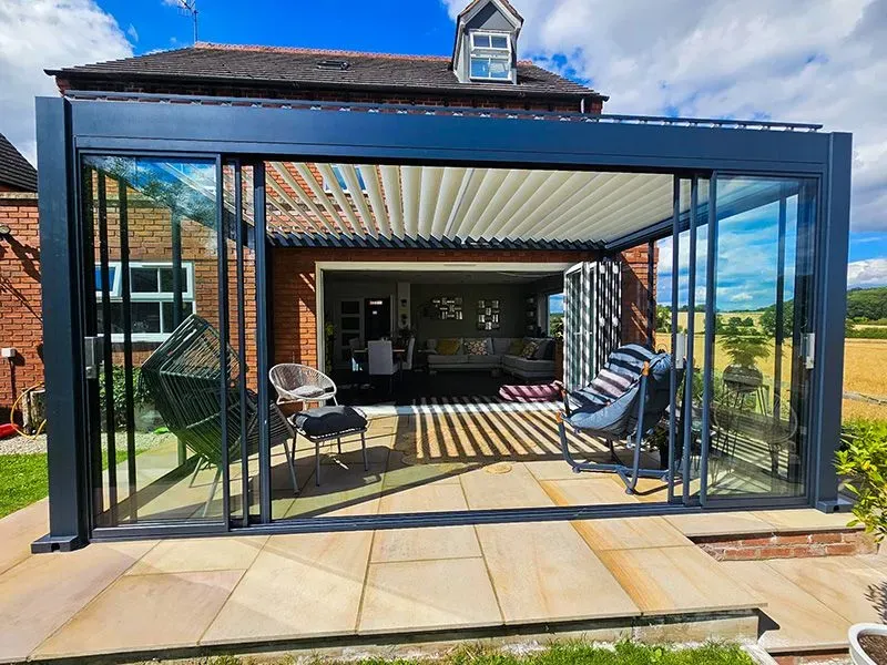 Mirage 4 x 3m bioclimatic pergola installed beside a house with adjustable louvred roof
