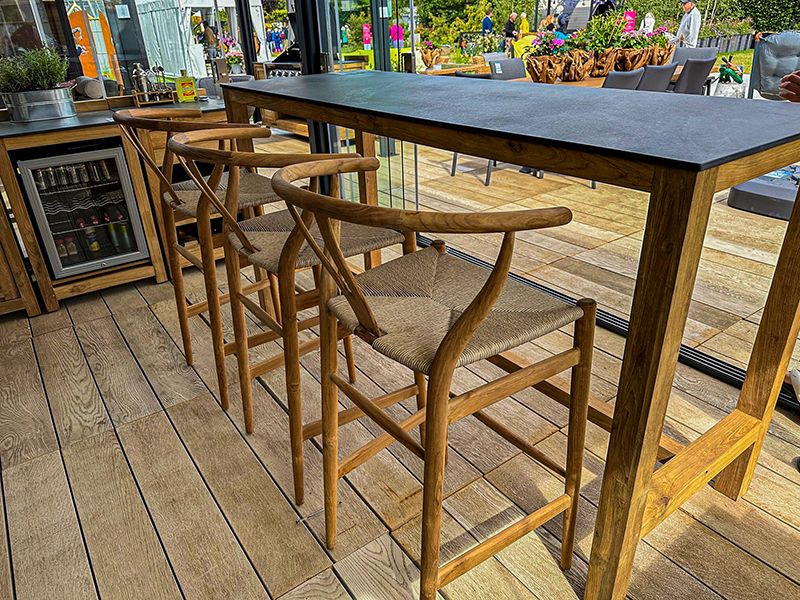 Bari teak bar table and four woven bar chairs in outdoor entertaining area
