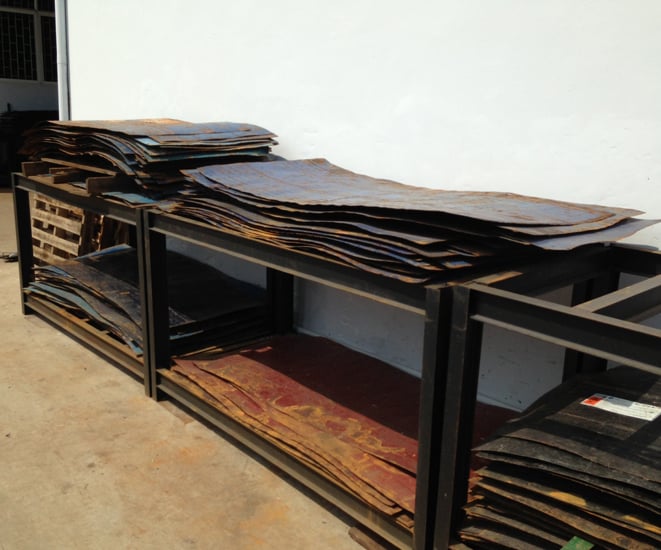 Recycled shipping drums are cut and flattened before being cleaned