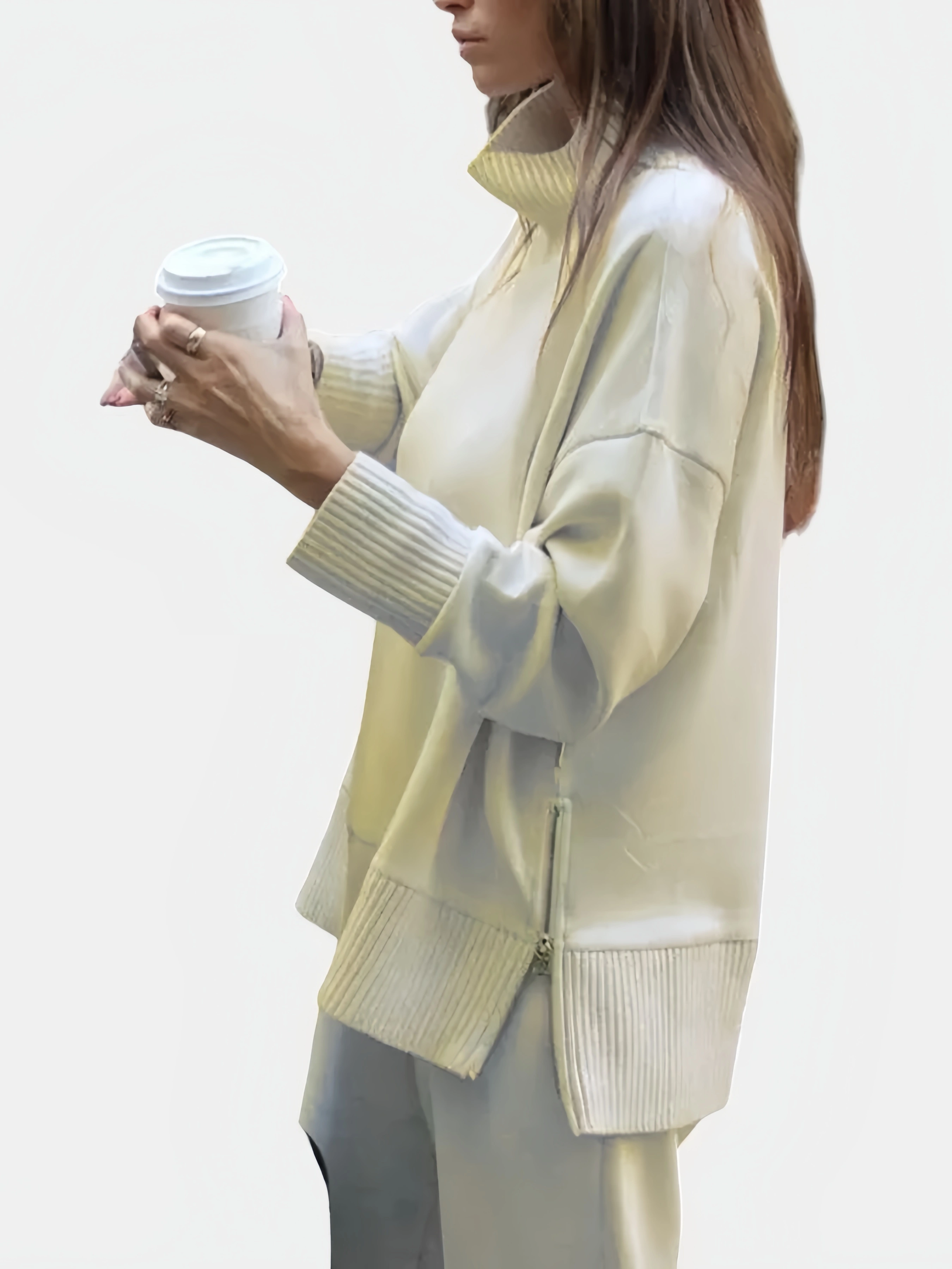 Apricot turtleneck top with wide-leg pants, holding a coffee
