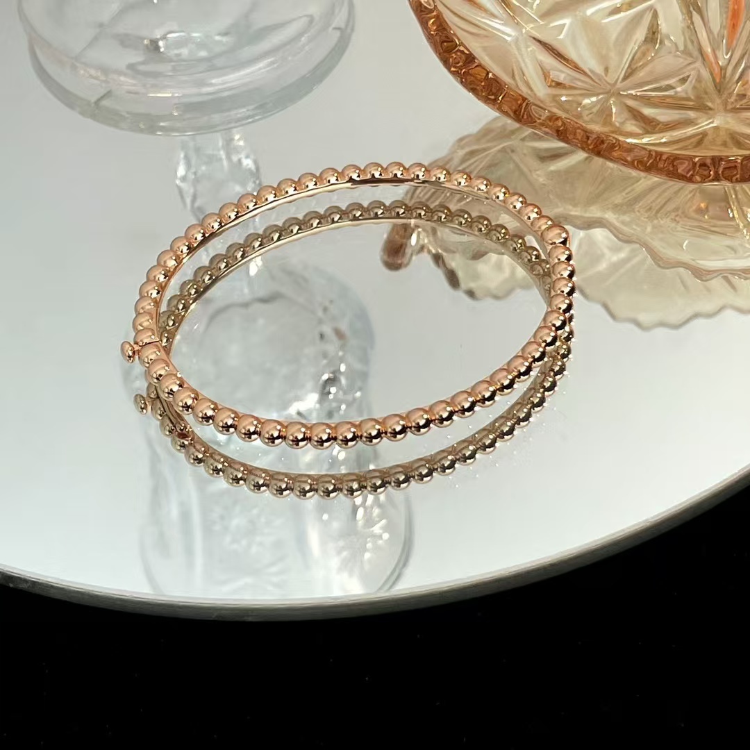 Buy replica Van Cleef & Arpels Perlée Pearls of Gold Bracelet - Medium Bangle and replica jewelry from PICKS Jewelry