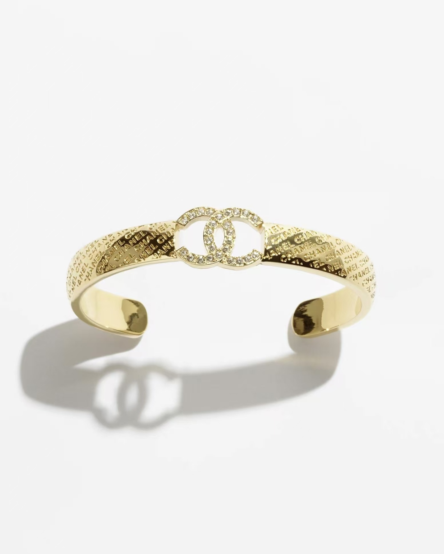 Buy replica Chanel Hollow Diamond Paved Double C Open Bangle Bracelet and replica jewelry from PICKS Jewelry