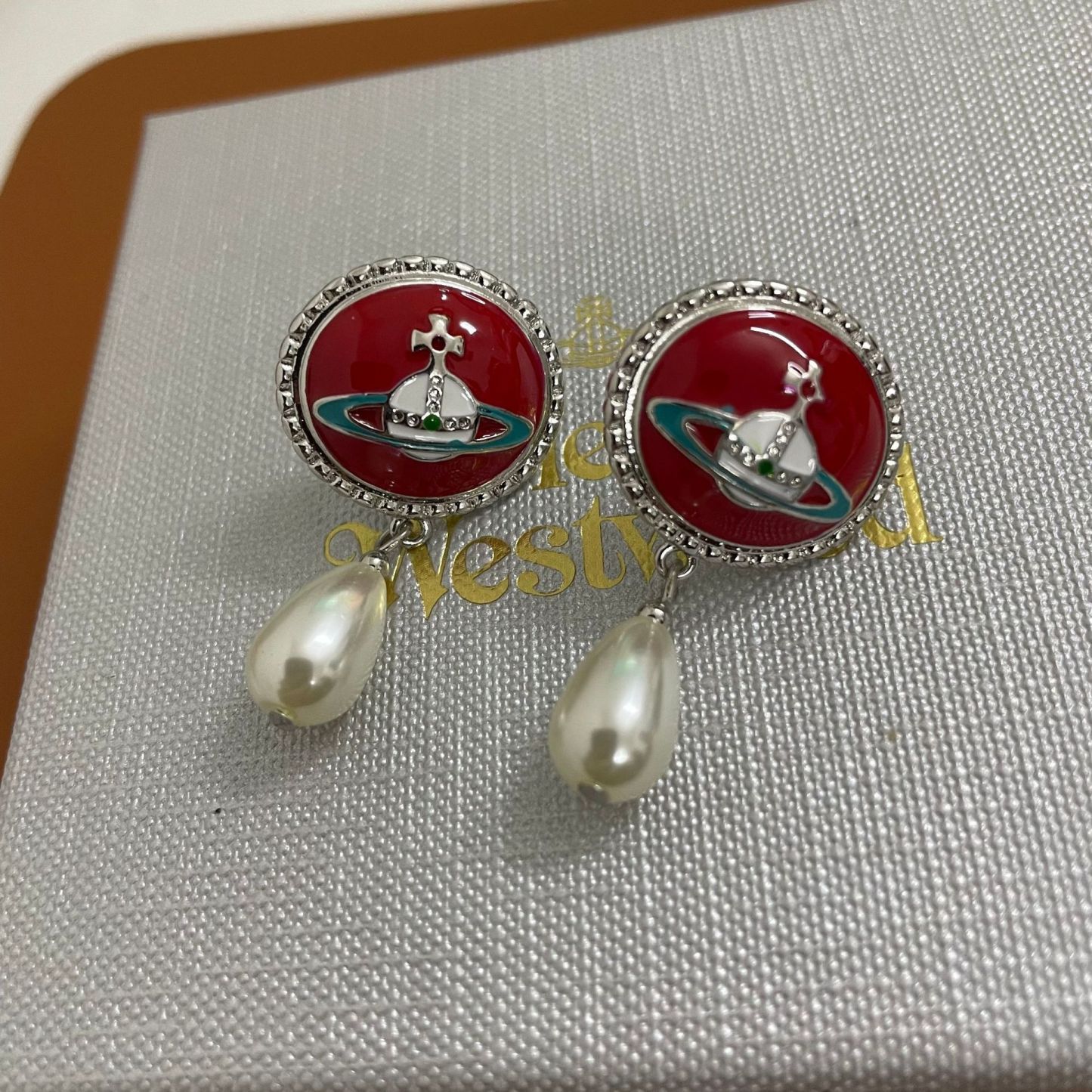 Buy replica Vivienne Westwood Enamel Saturn Waterdrop Pearl Earrings and replica jewelry from PICKS Jewelry