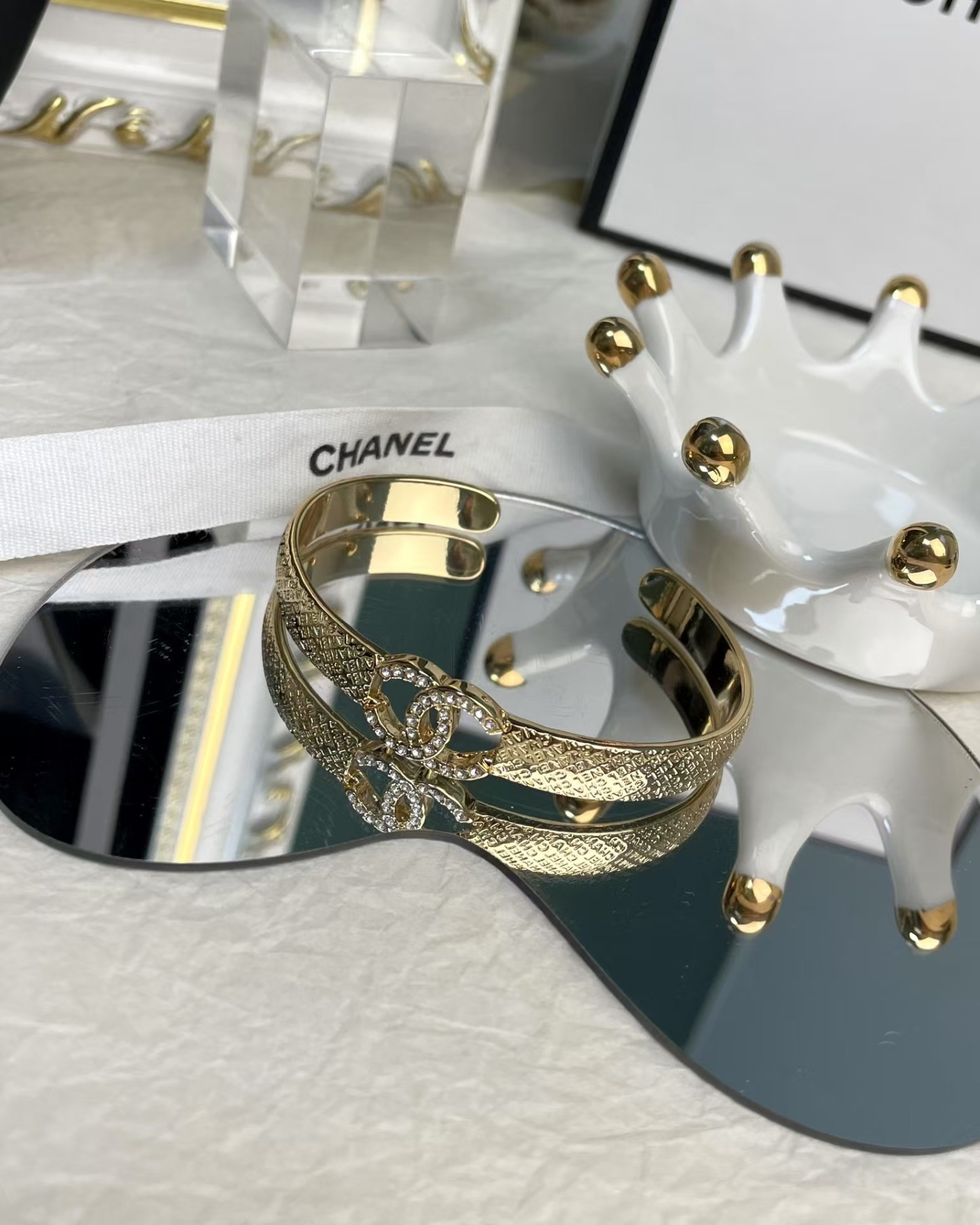 Buy replica Chanel Hollow Diamond Paved Double C Open Bangle Bracelet and replica jewelry from PICKS Jewelry