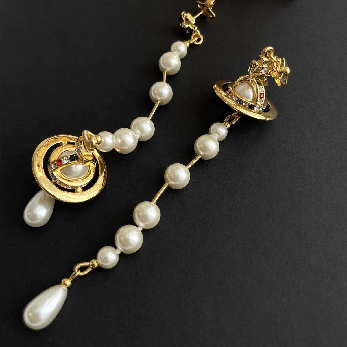 Buy replica Vivienne Westwood Asymmetric Tassel Pearl Saturn Earrings and replica jewelry from PICKS Jewelry