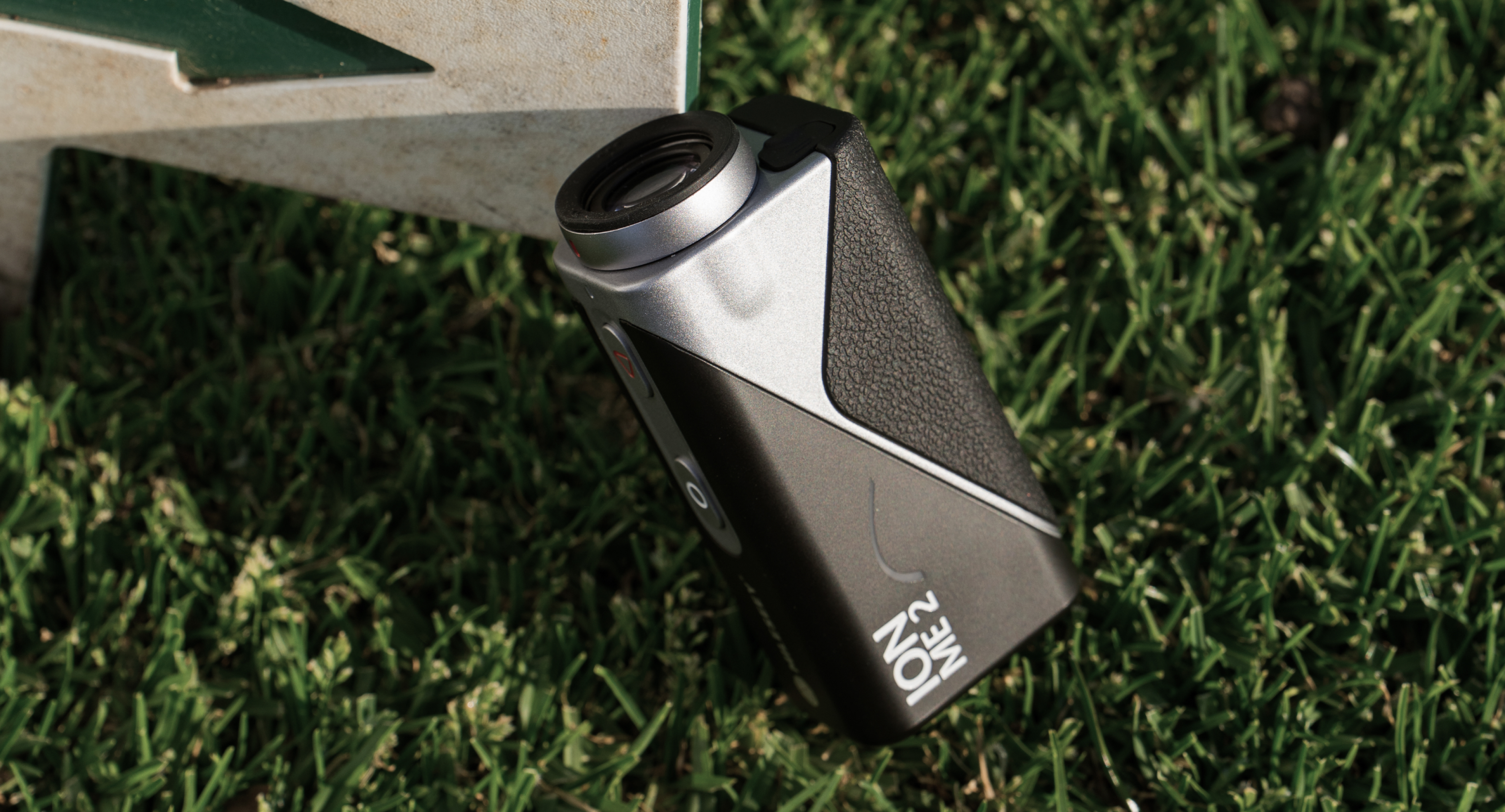 Mileseey IONME2 laser rangefinder resting on the golf grass