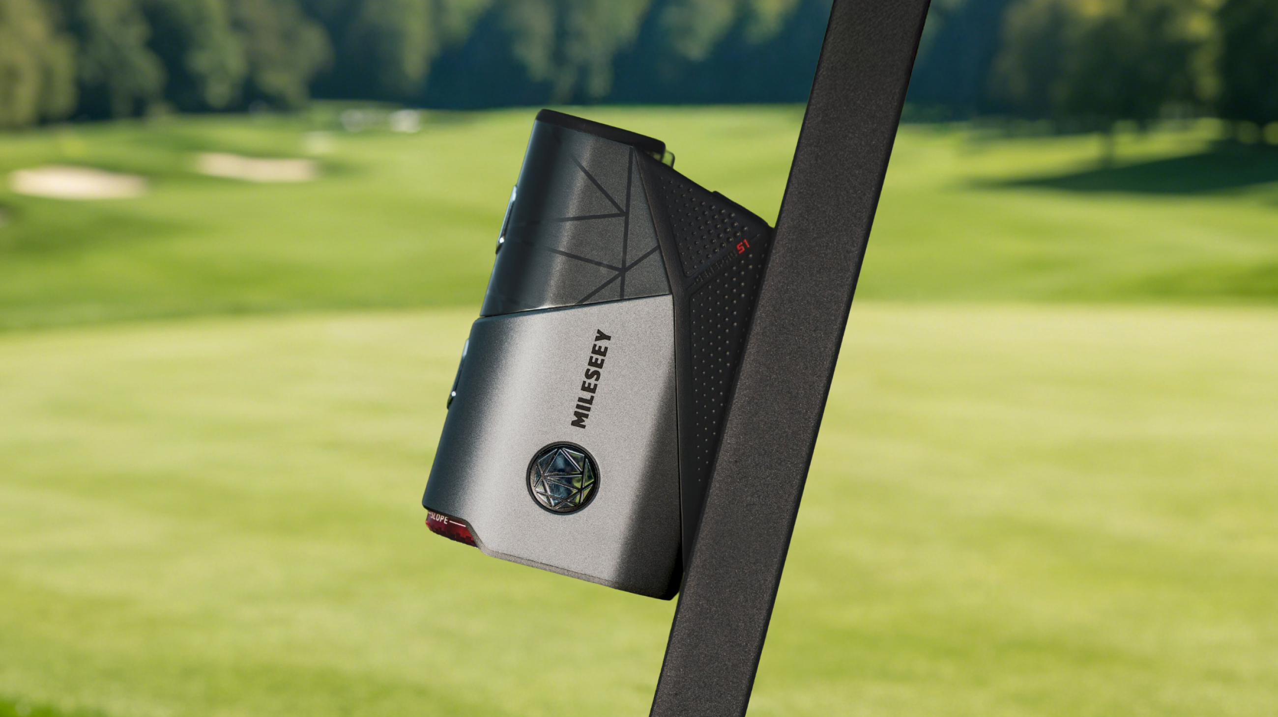 Mileseey GenePro S1 rangefinder magnetically attached to a golf club shaft, fairway in the background