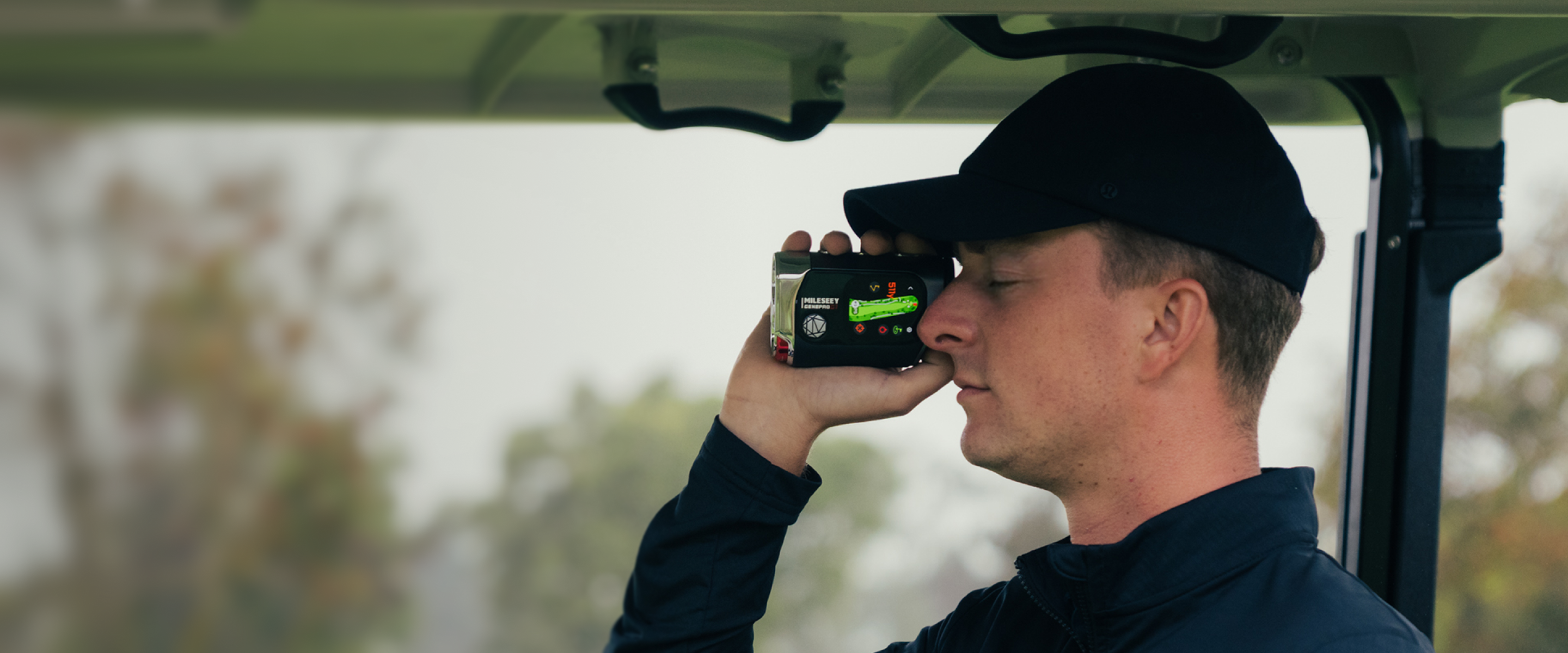 The golfer checking distances with the MILESEEY GenePro G1 golf laser rangefinder