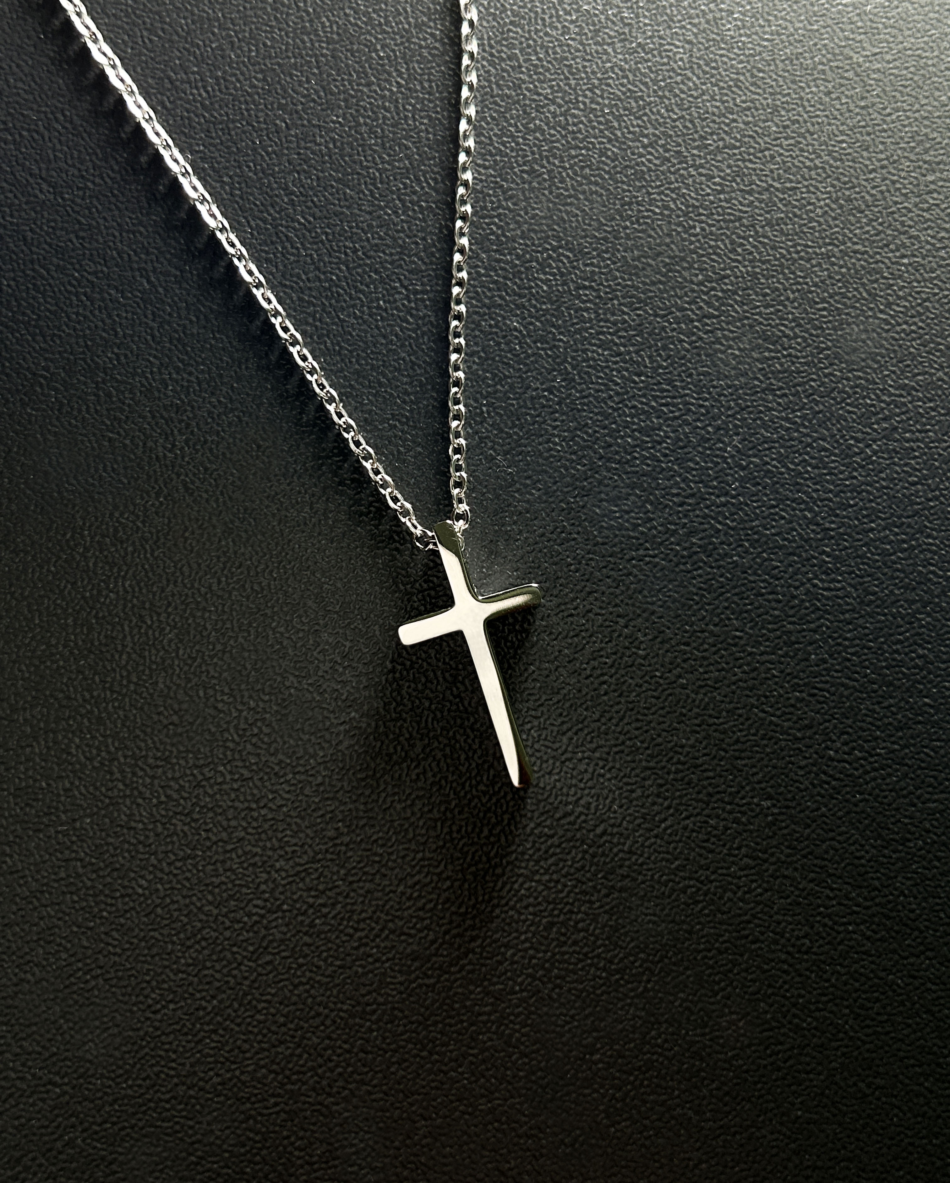 Sleek silver cross necklace paired with an innovative NFC-enabled keychain for accessing scripture verses on the go, tailored for spiritually active lifestyles.