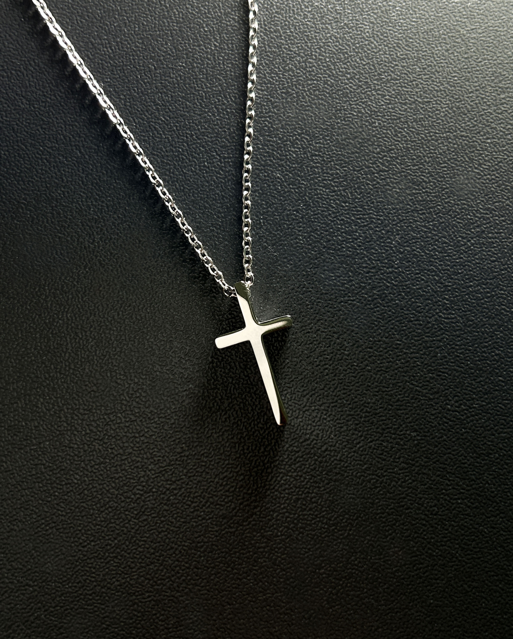 Sleek silver cross necklace paired with an innovative NFC-enabled keychain for accessing scripture verses on the go, tailored for spiritually active lifestyles.