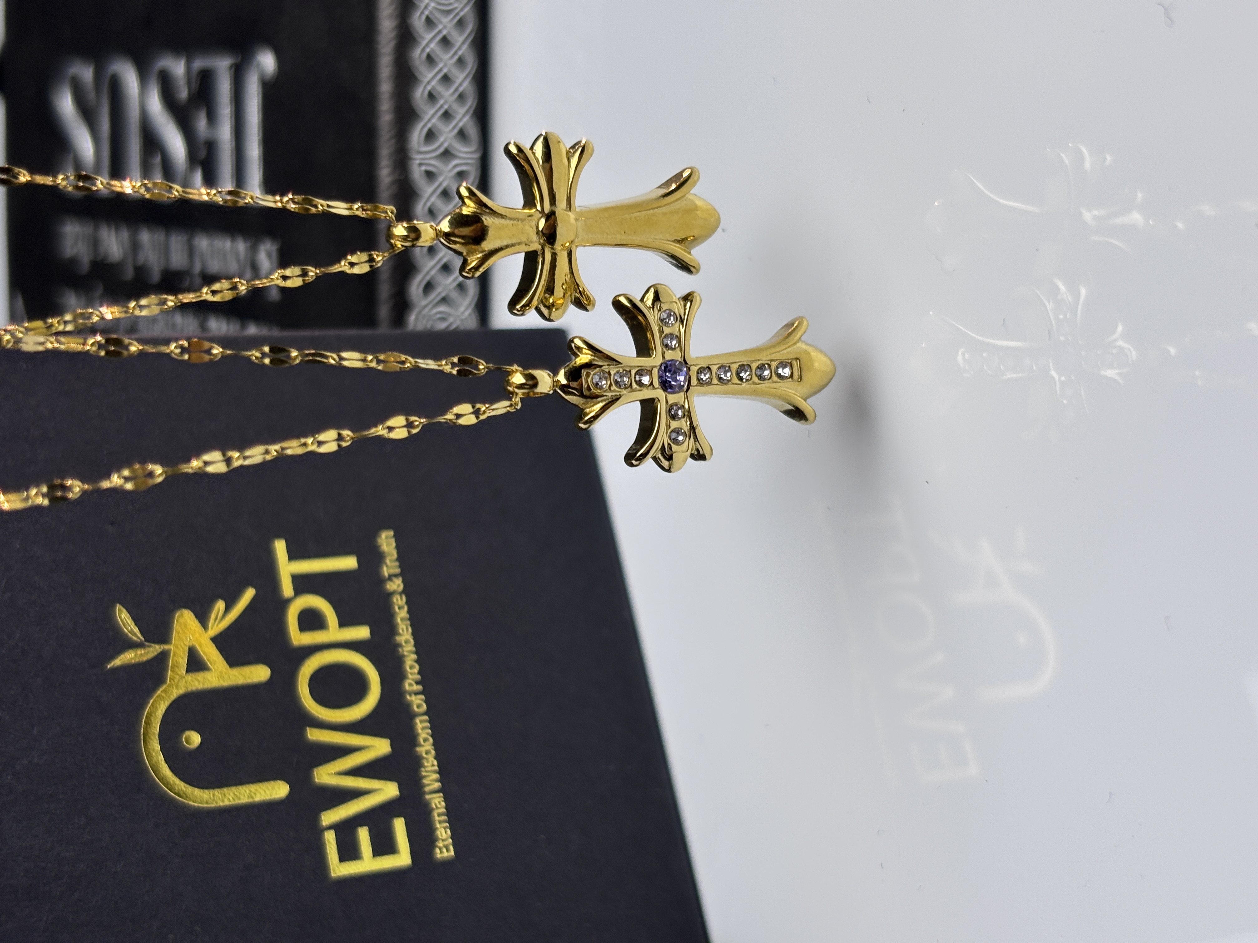 Elegant cross necklace in gold with jewel details, comes with a unique NFC keychain to unlock daily blessings from the Bible.