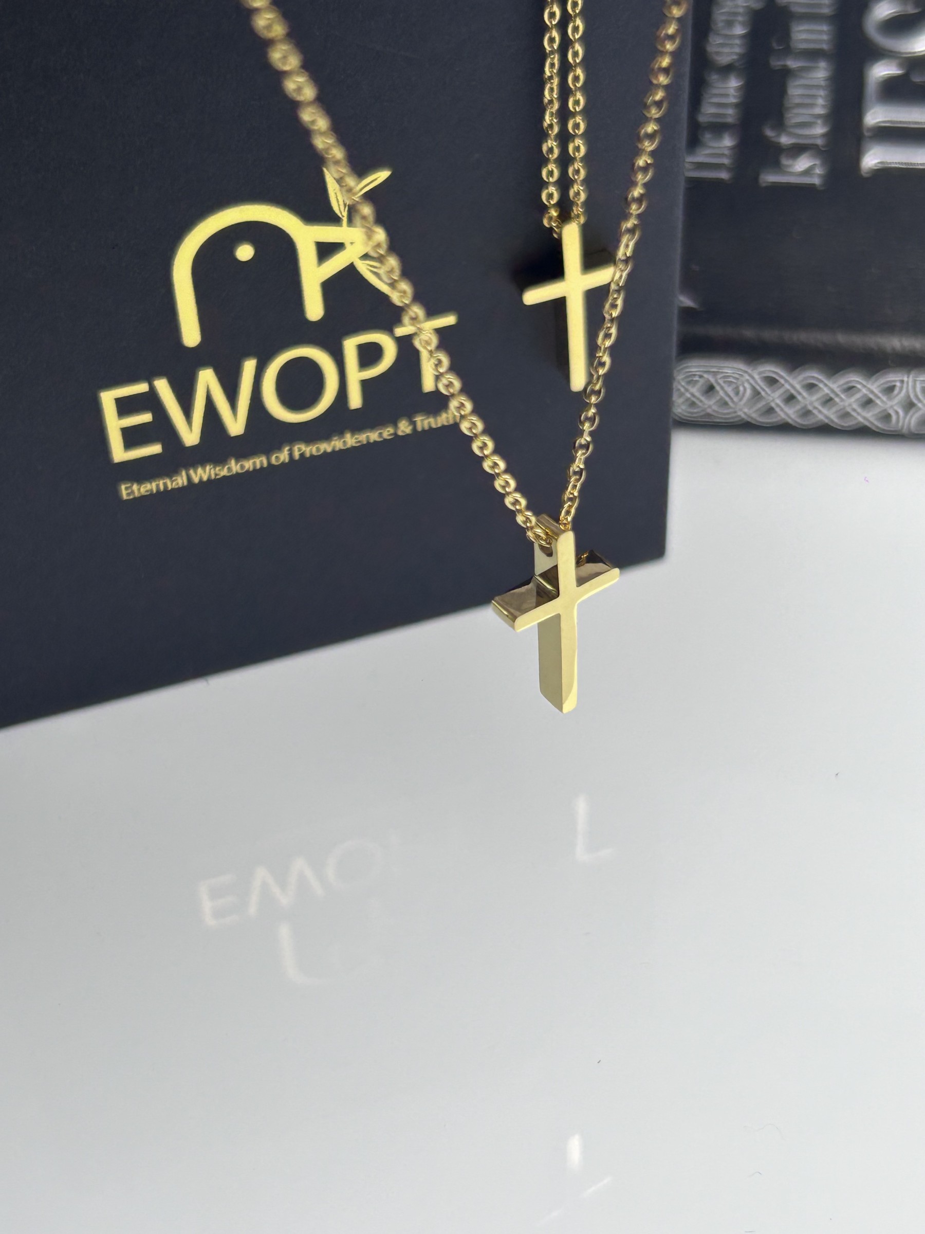 Elegant gold cross necklace complemented by an NFC-enabled keychain for immediate access to scripture, merging classic elegance with digital innovation.