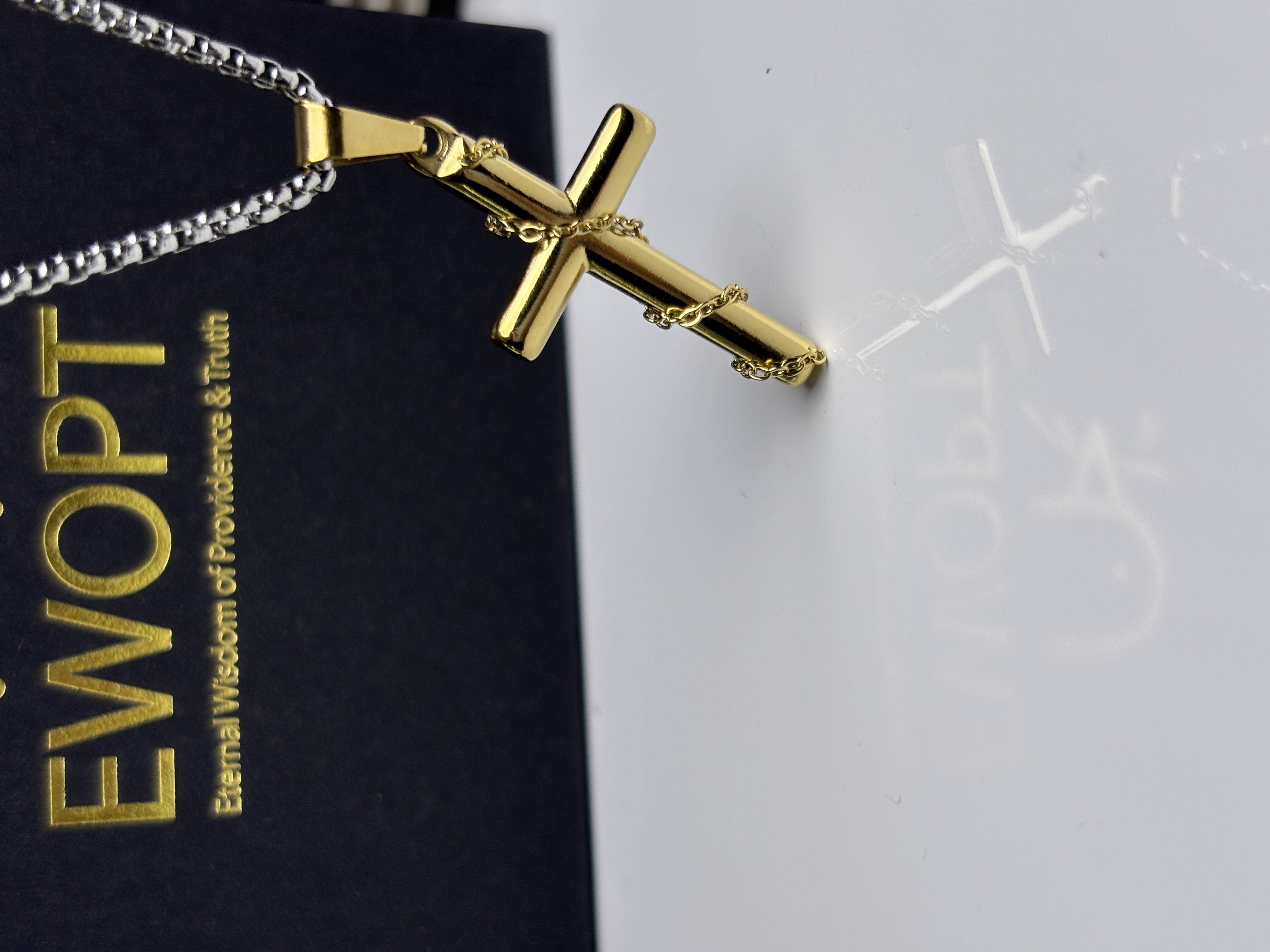 Stylish gold cross necklace with a sleek design, featuring an NFC keychain that offers quick access to daily Bible scriptures, combining fashion with faith.