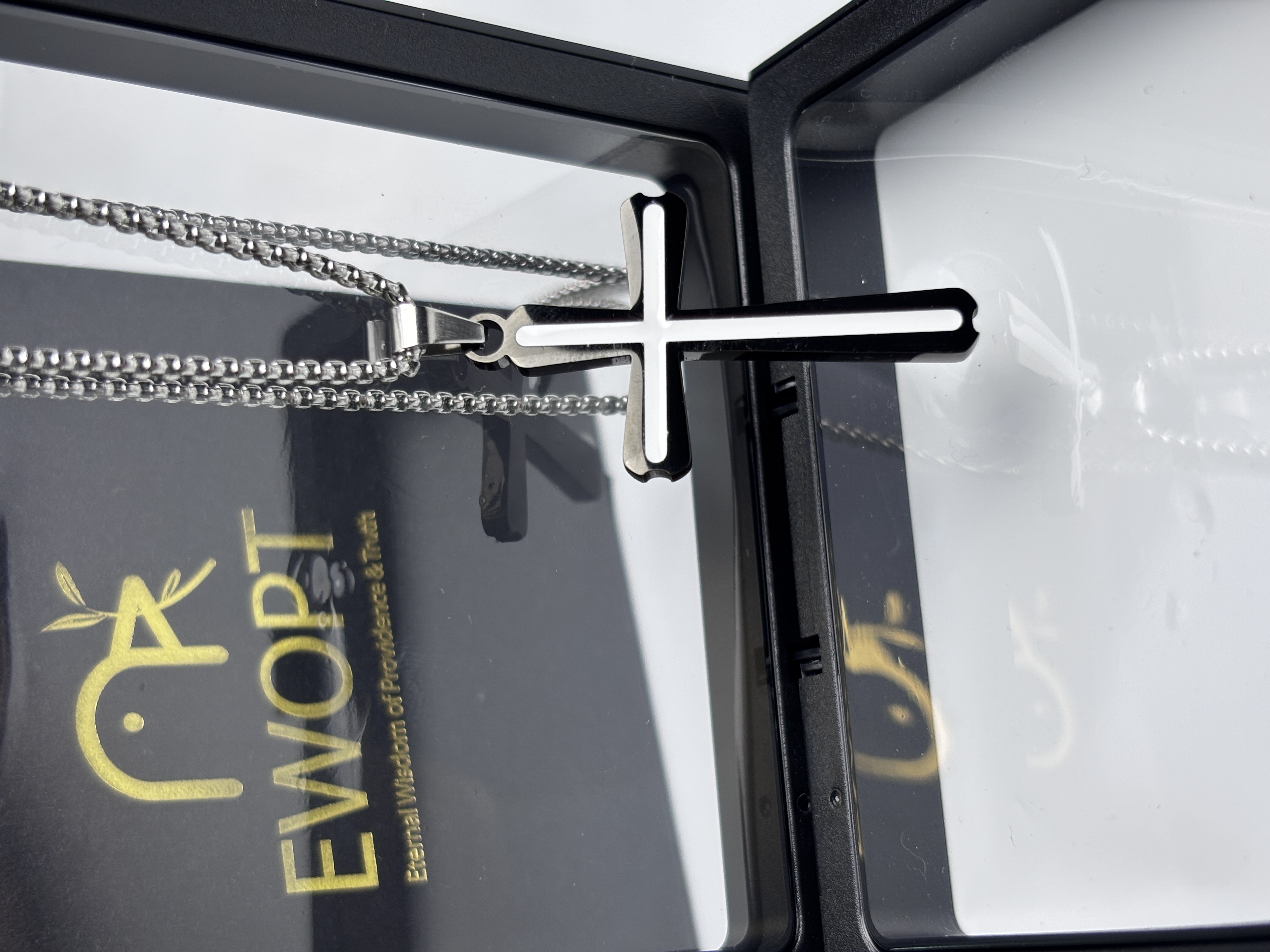 This striking stainless steel cross necklace features a bold carbon fiber design, paired with an NFC keychain that accesses daily biblical scriptures, offering a modern approach to wearable faith.