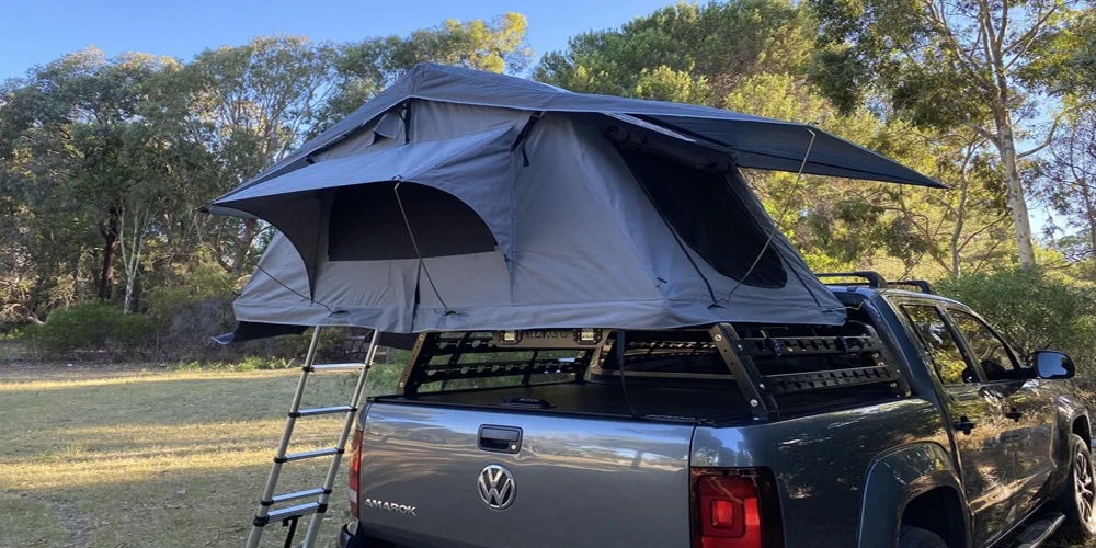 Overlander 4'4 roof top tent mounted on SUV with customizable window in nature setting