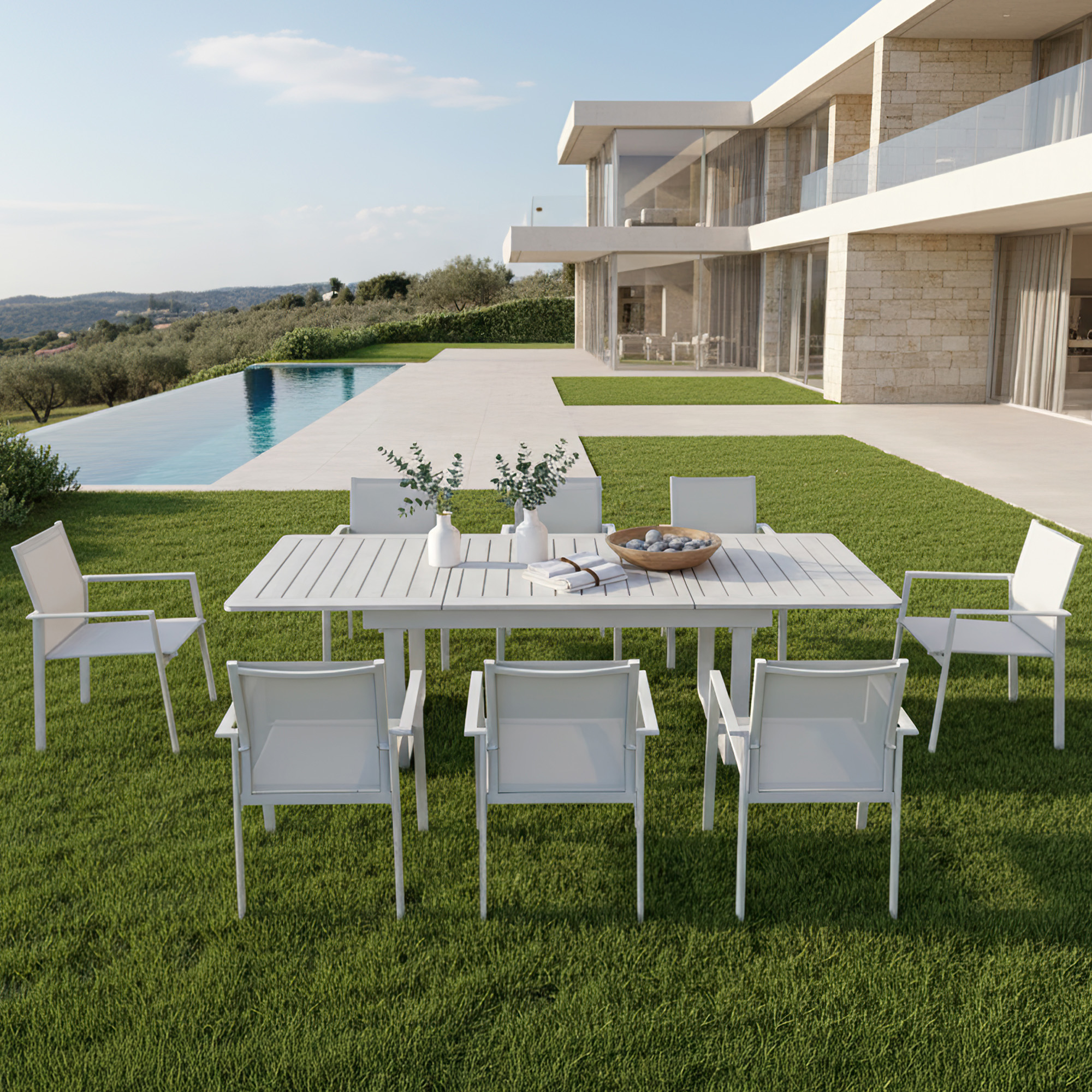 White extendable outdoor dining table with eight chairs on green lawn by pool-Seehill