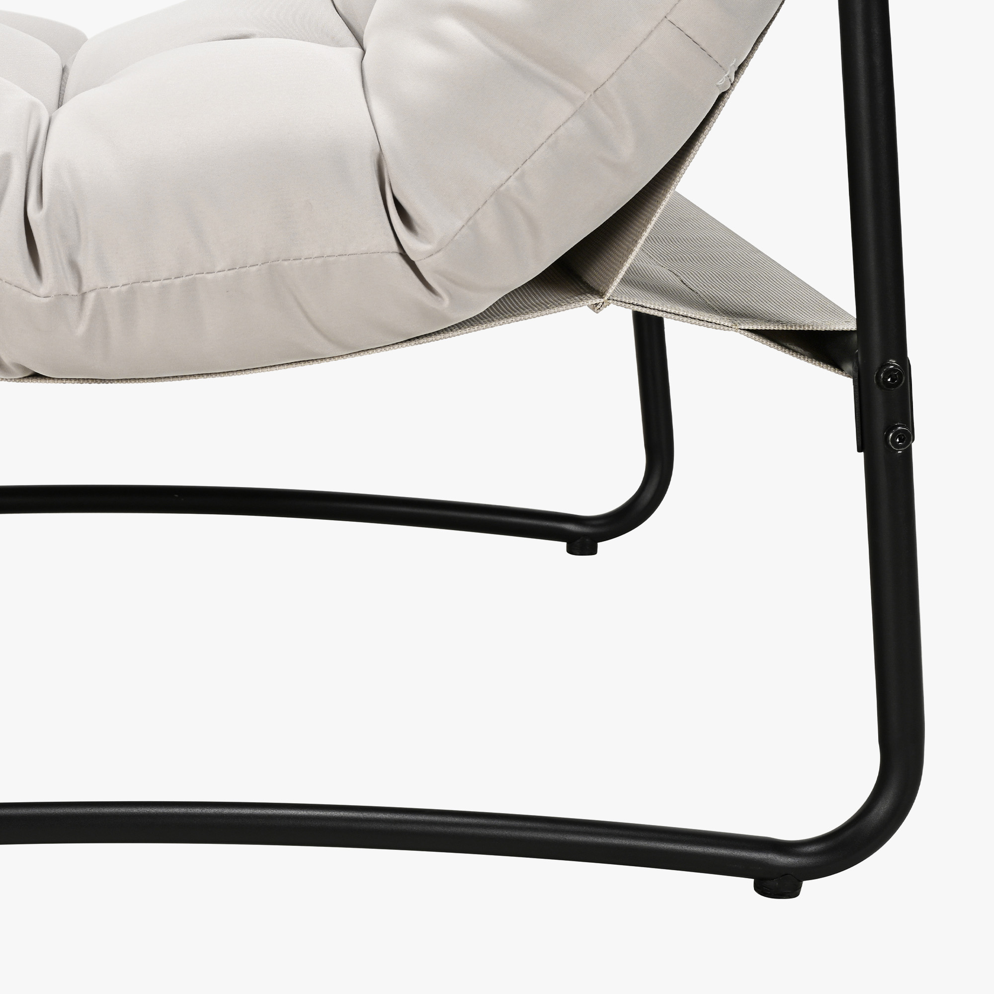 Close-up of metal frame and beige cushioned seat of modern patio rocking chair -Seehill