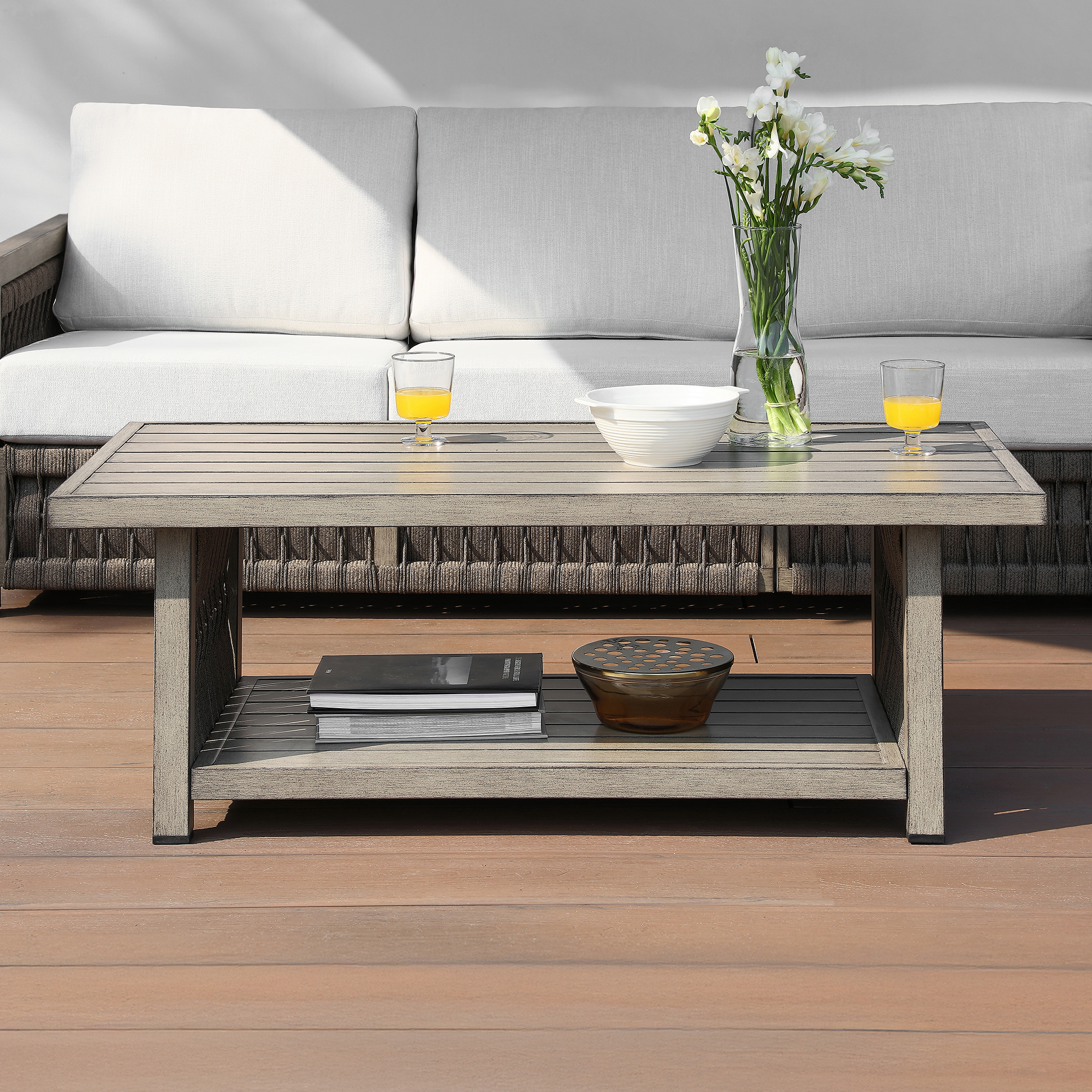 An artistic outdoor patio coffee table with aluminum frame, rope weave design, and tiered storage design that adds character to your patio. - Seehill