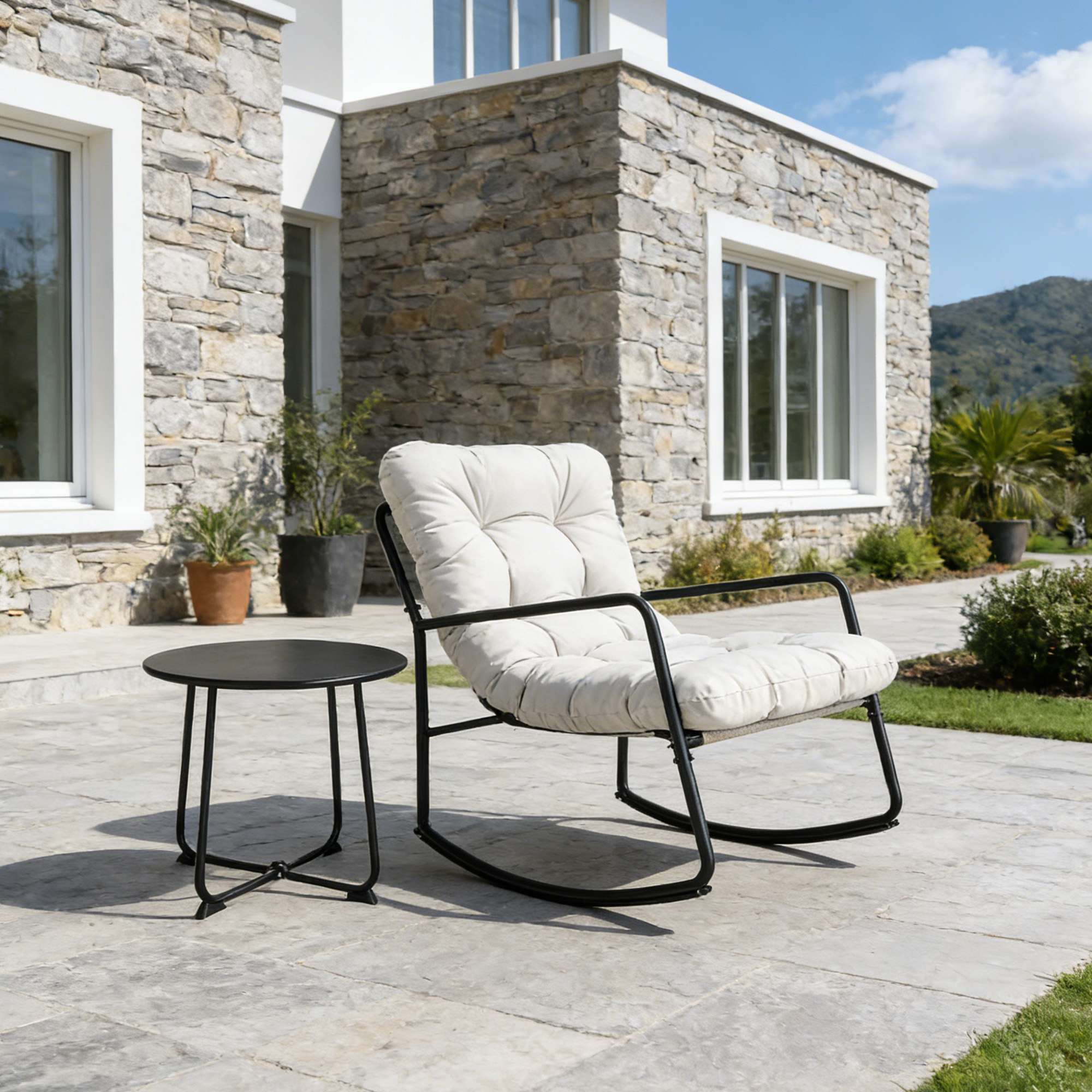 Modern metal patio rocking chair with cushioned seat and matching round side table outdoors-Seehill
