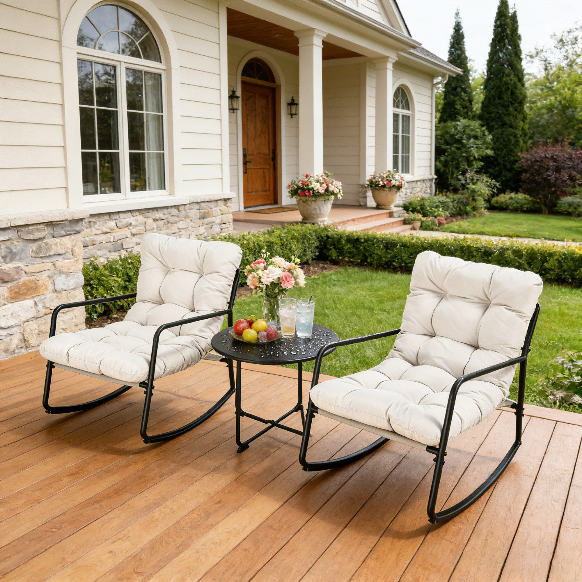 Two cushioned metal rocking chairs with a small round table on a wooden patio-Seehill