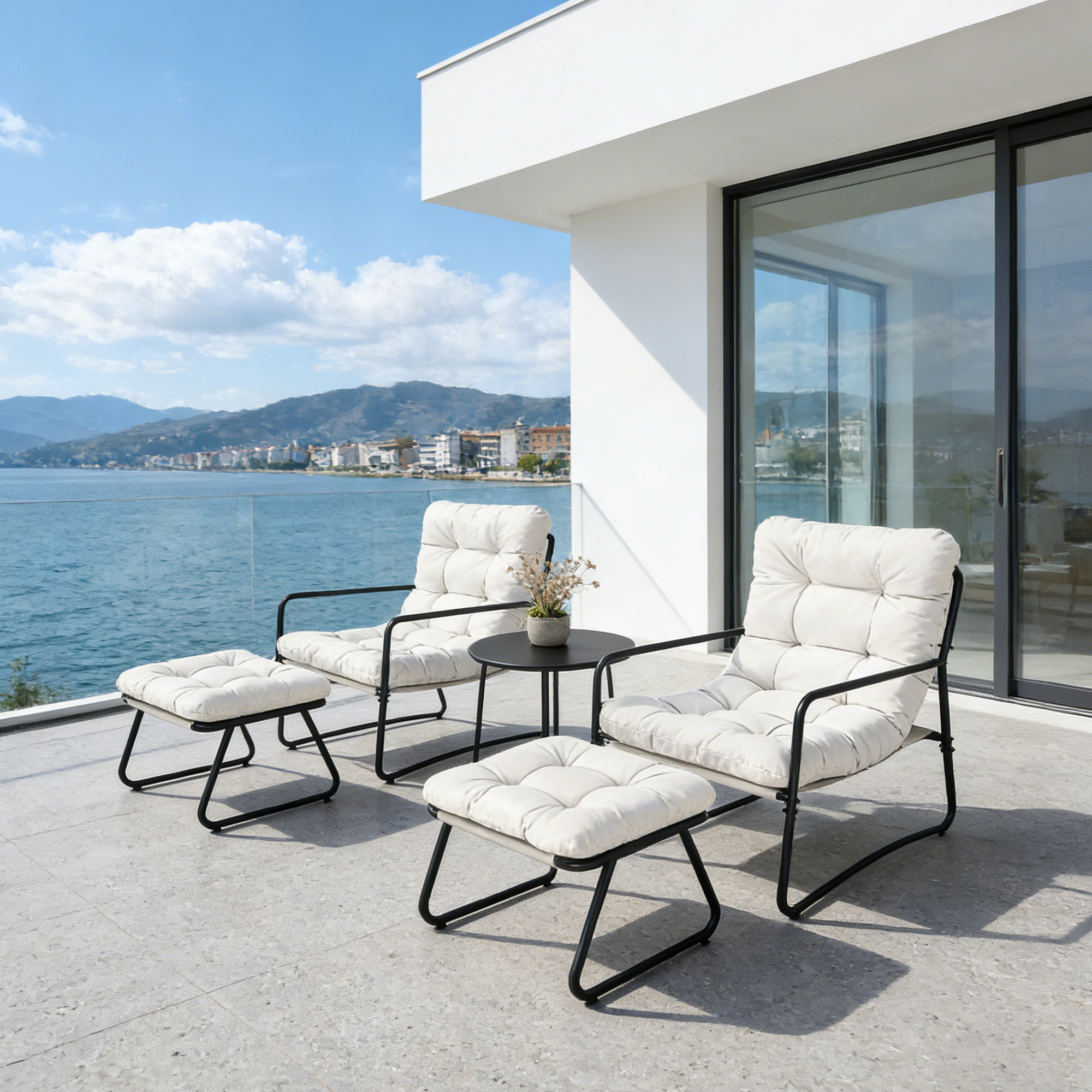 Modern patio rocking chairs with cushioned seats and ottomans on a balcony by the sea -Seehill