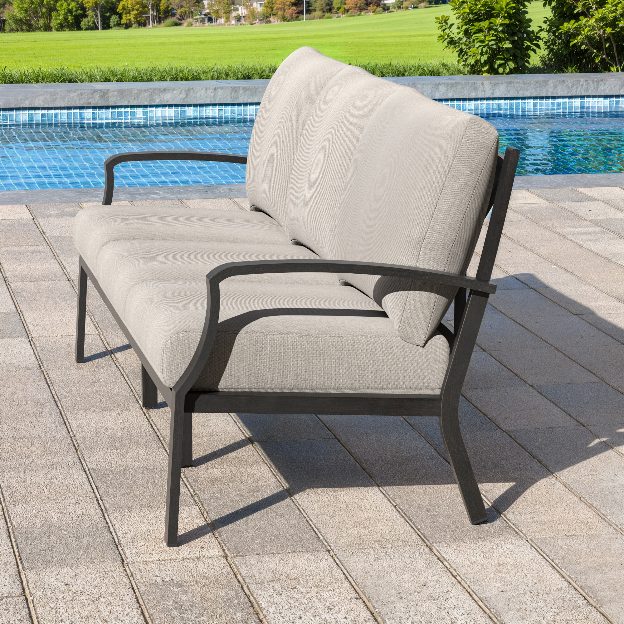 Spacious outdoor patio sofa with light cushions and dark metal frame by the poolside-Seehill