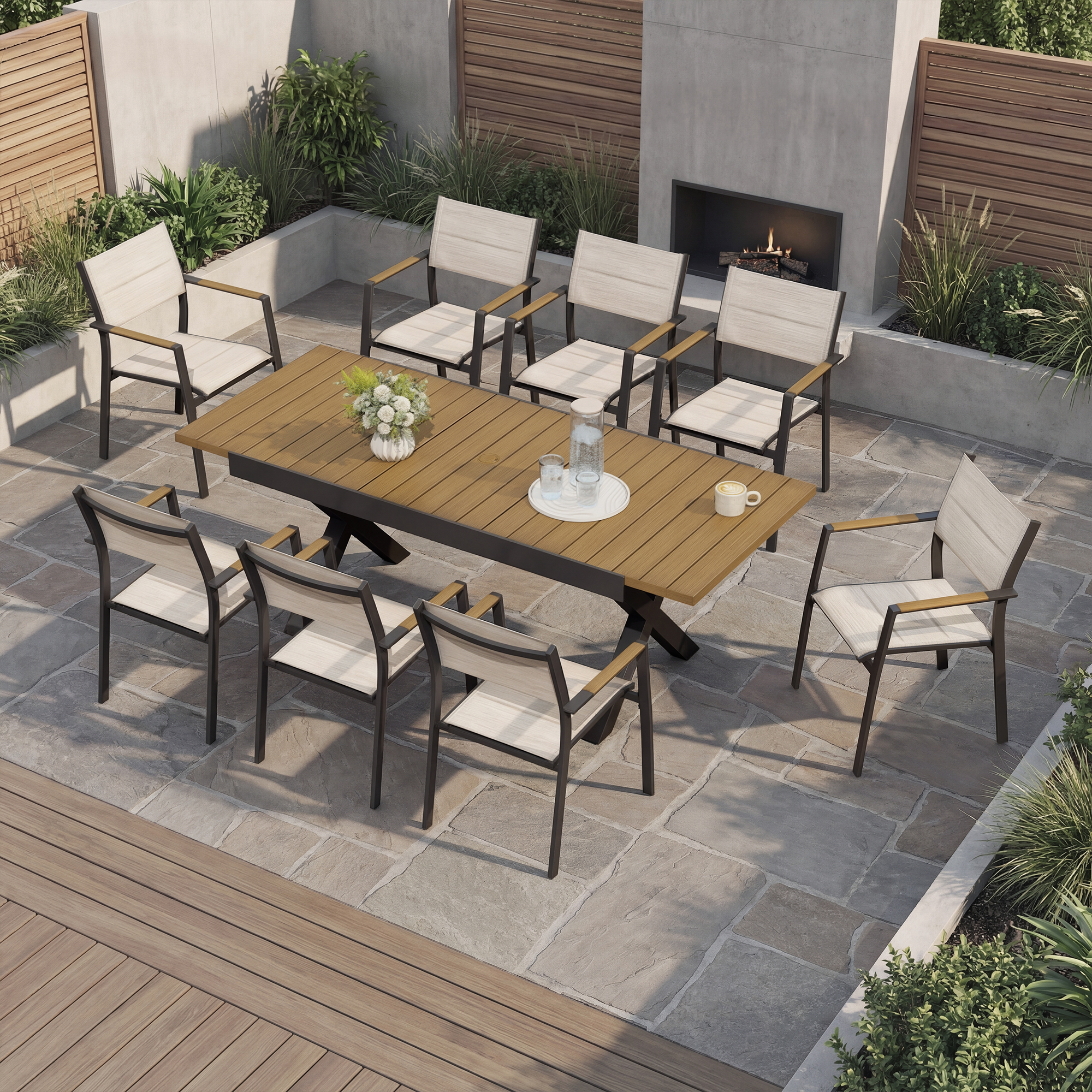 Expandable outdoor dining set with stackable chairs arranged on a stone patio near fireplace-Seehill