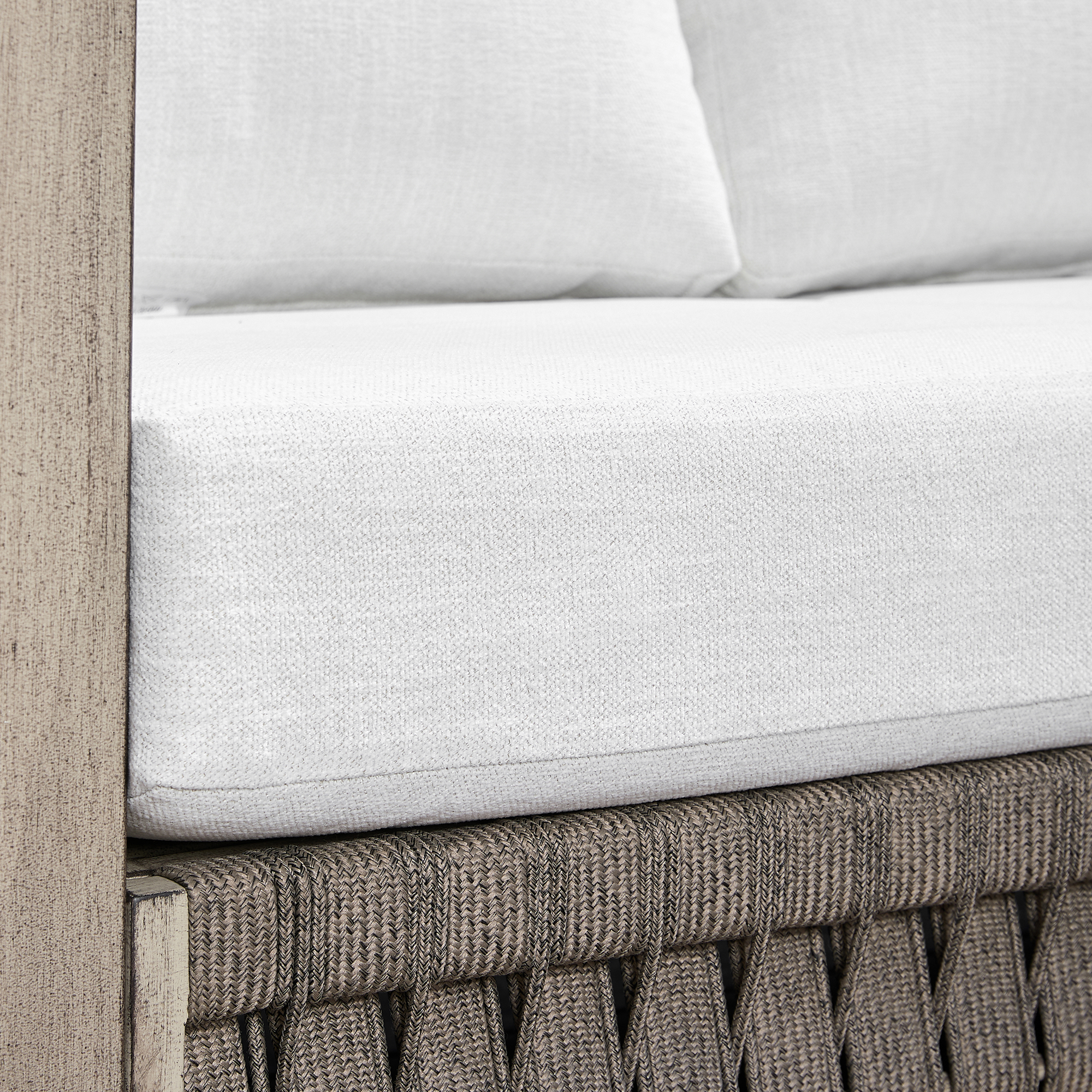 Highlighting the modern outdoor sofa with a gray woven frame and white cushions of this refined Seater Outdoor set. - Seehill