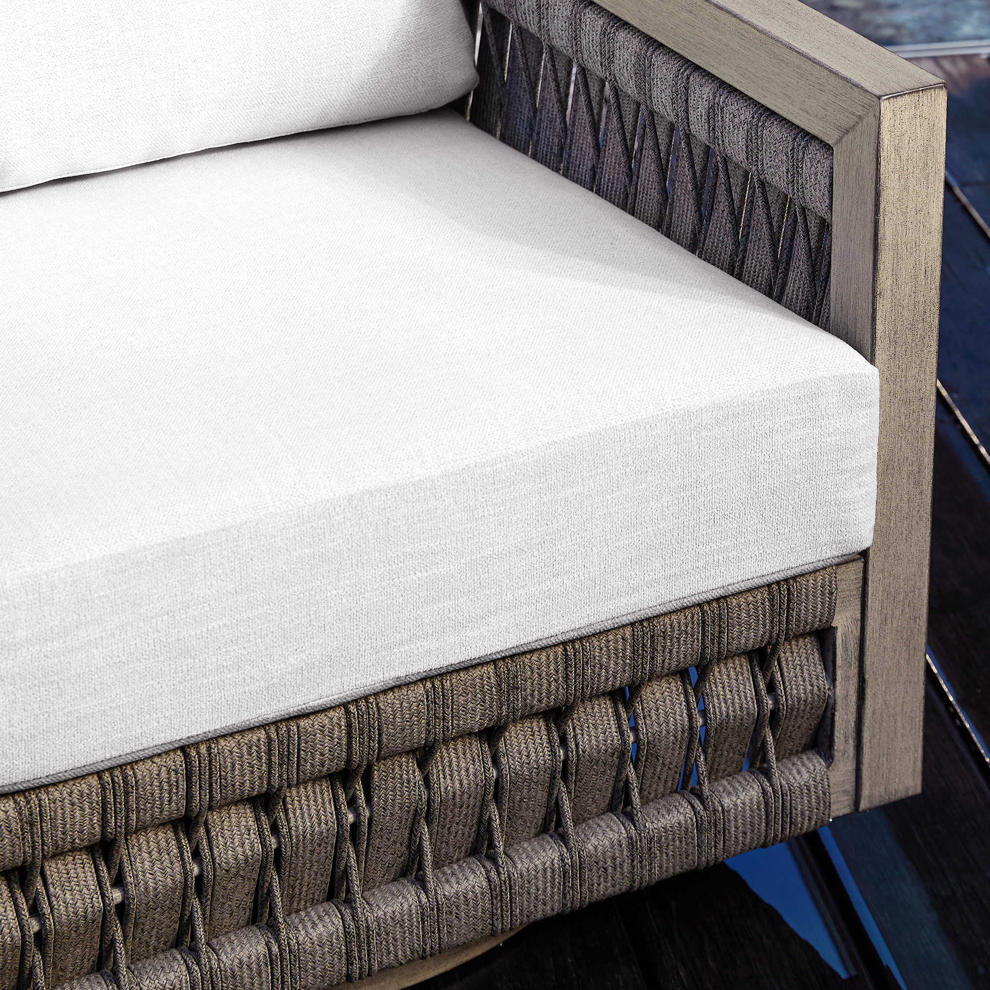 Highlighting the modern outdoor sofa with woven frame and white cushion, this refined oversize piece adds elegance to any patio. - Seehill