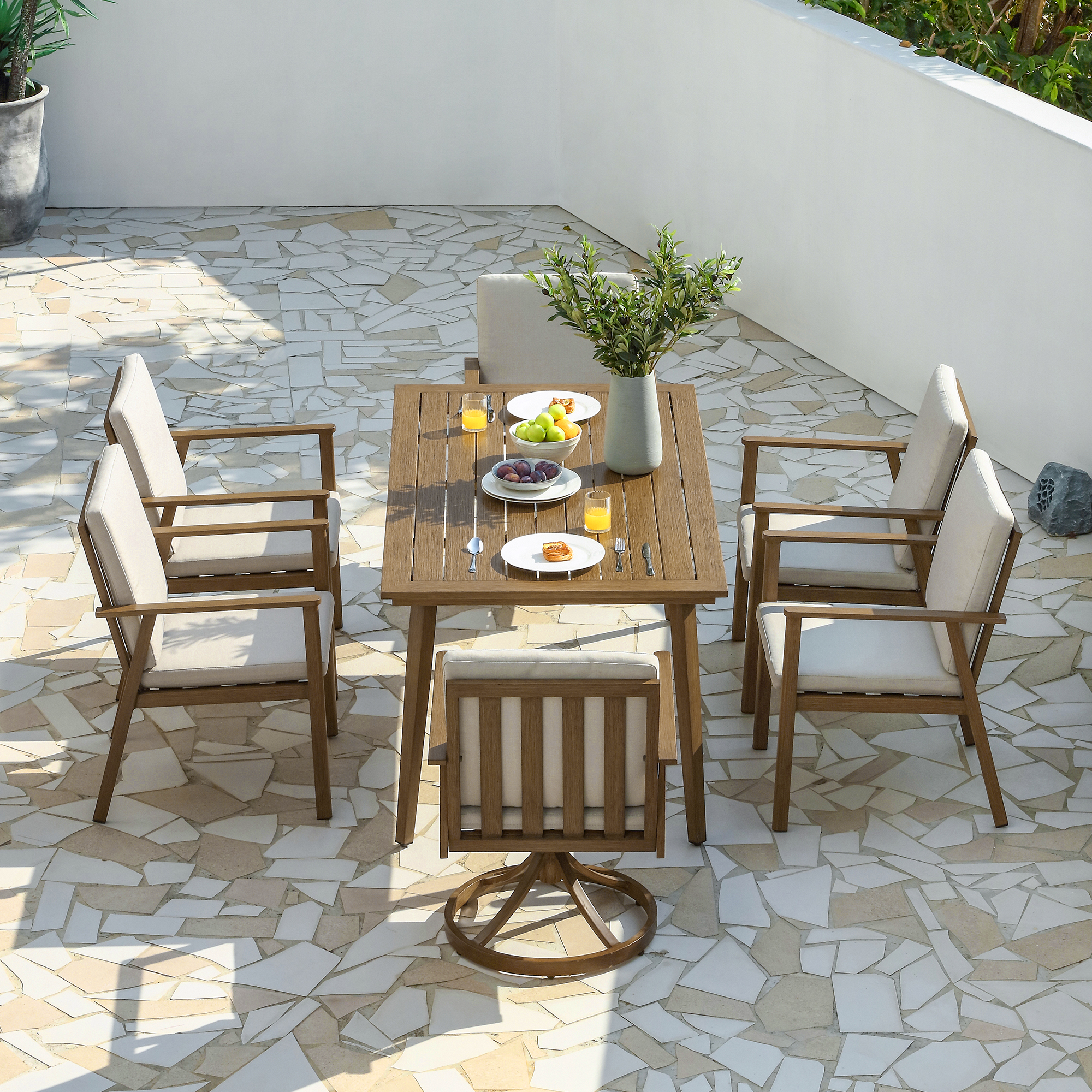 Luxury aluminum outdoor patio dining set with all-weather swivel chairs and an umbrella hole for dining. - Seehill