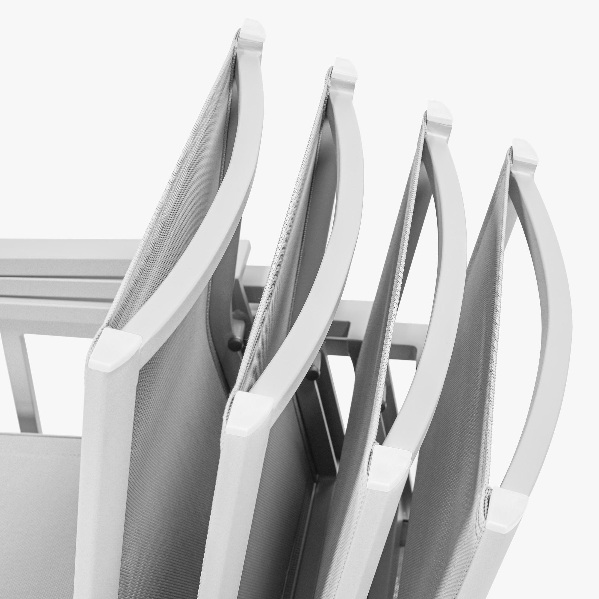 Close-up of stackable patio dining chairs with textile seats and backs on white background -Seehill