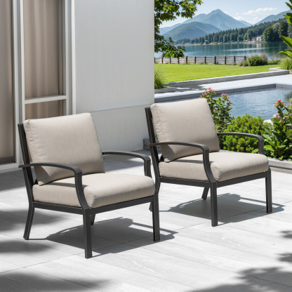 Two cushioned patio armchairs on a sunny terrace overlooking a pool and mountain view -Seehill